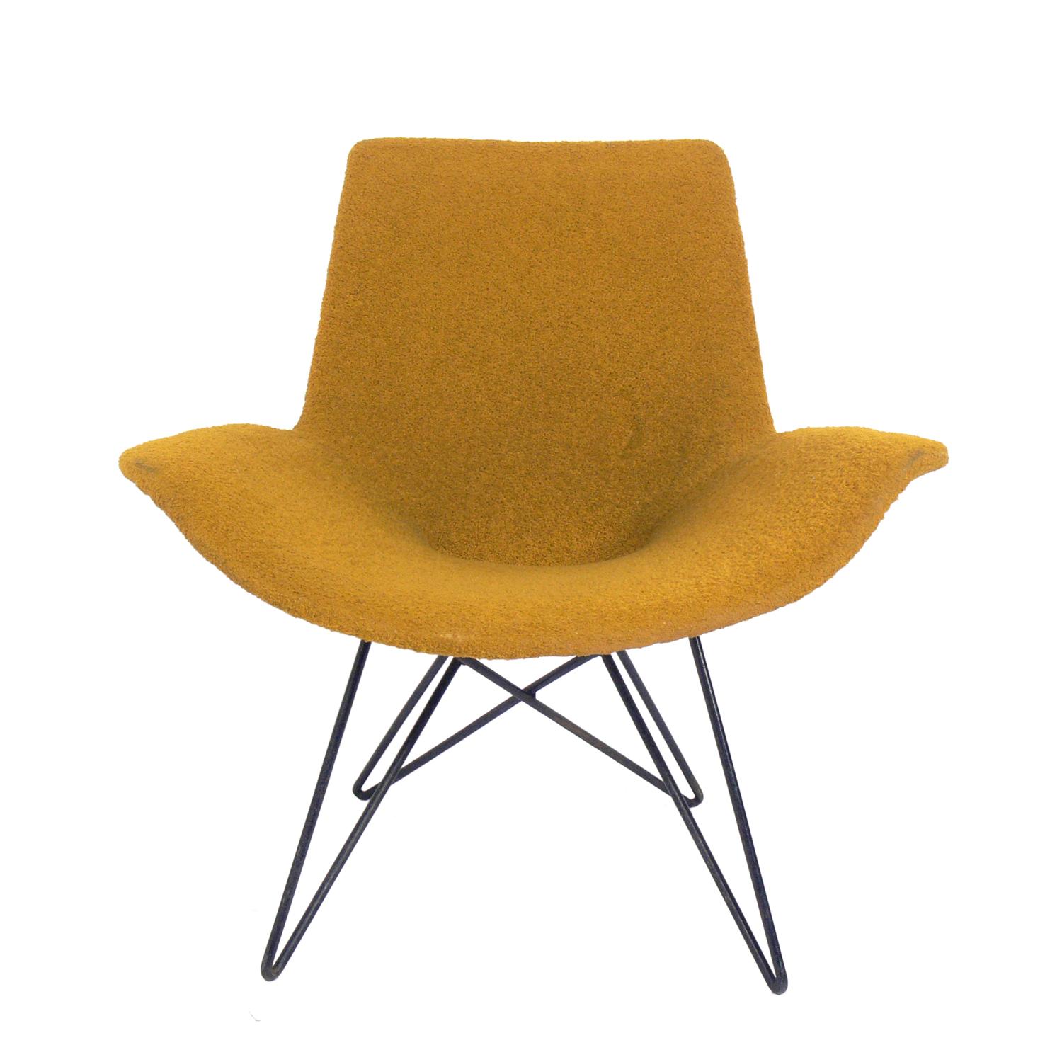 Curvaceous midcentury chair, attributed to Martin Eisler, Brazil, circa 1950s. Retains its original yellow bouclé upholstery and original patina to the iron base.
