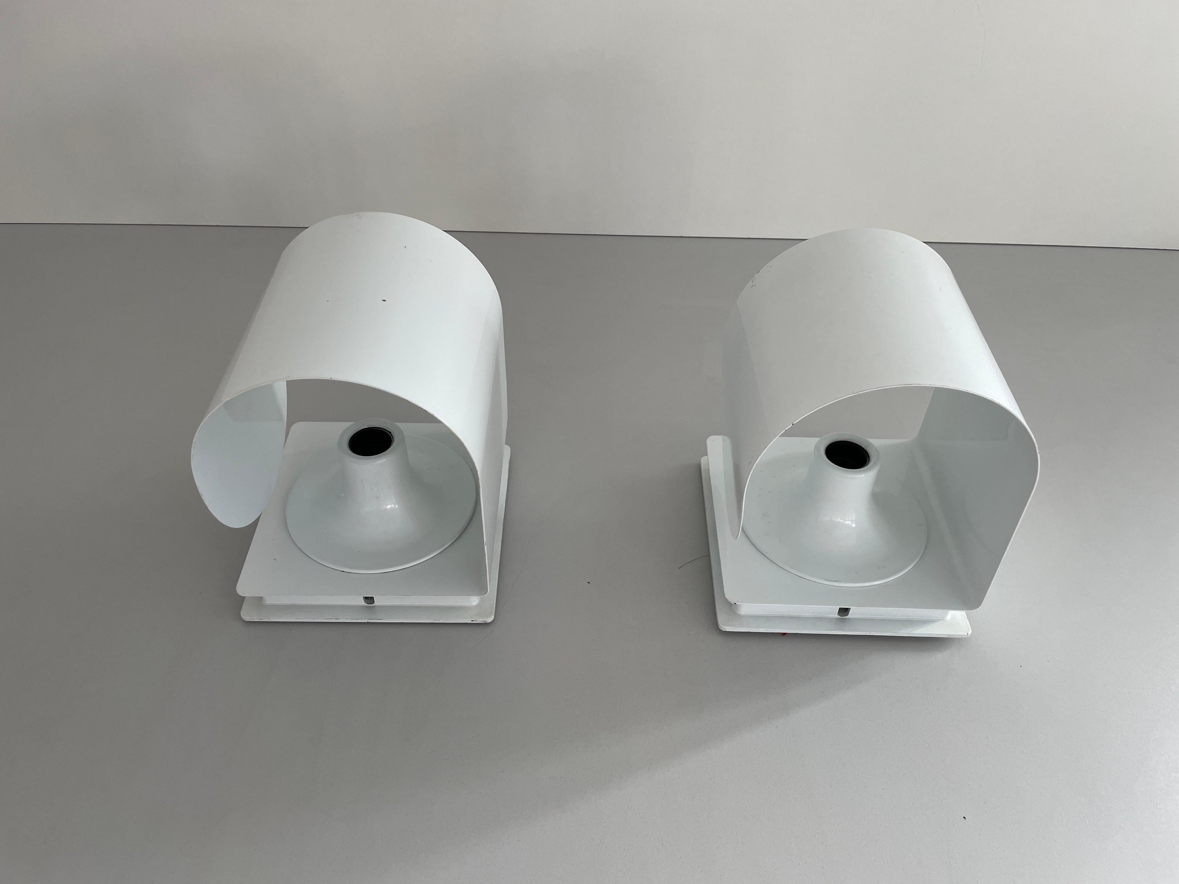 Curve Shaped White Metal Space Age Pair of Sconces, 1970s, Italy

Very elegant and minimal design wall lamps
Lamp is in very good condition.

These lamps works with E27 standard light bulbs. 
Wired and suitable to use in all countries. (110-220