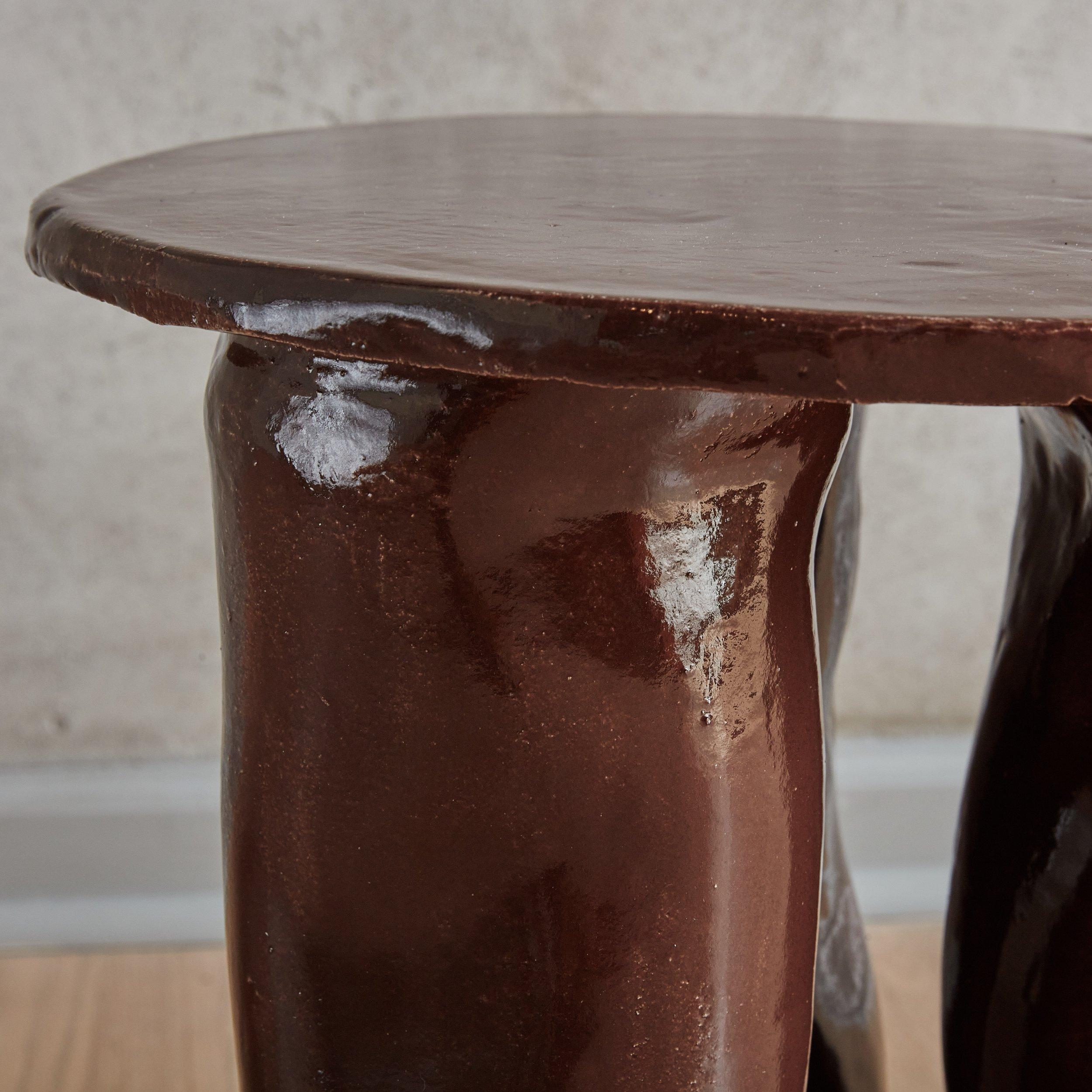 A contemporary ceramic side table designed by Chicago ceramicist, Paige Schlosser. 
 Models shown in Brown and Ivory are available and both In Stock. The Curve table is also available Made to Order with a 4 week lead time in natural, matte black,