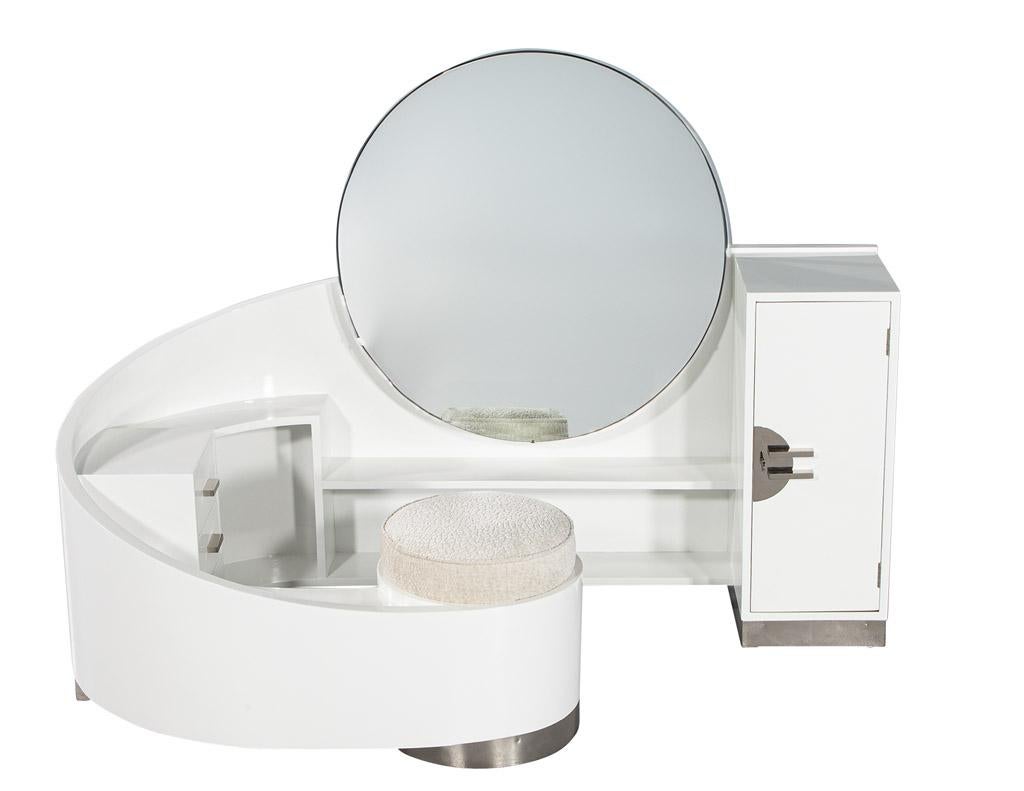 This stunning Modern Art Deco Style curved vanity, designed by the iconic French designer Paul Poiret, is an impressive work of art perfect for any bedroom. The vanity features a large round adjustable mirror, allowing you to adjust to your
