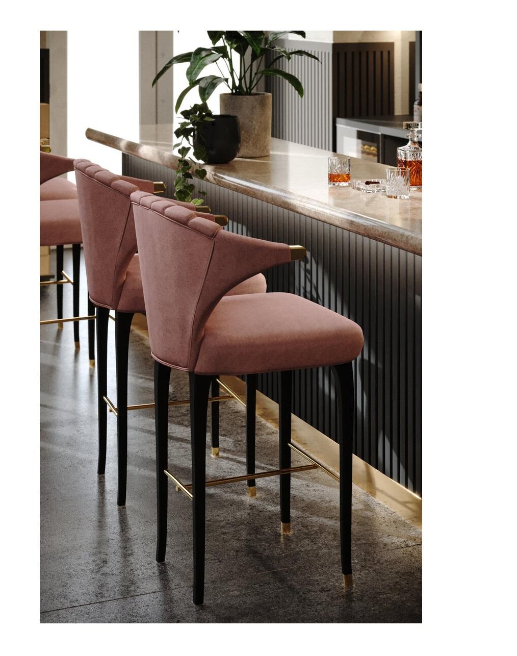 Contemporary elegant barstool upholstered in water repellent velvet. Constructed with lacquered wood frame and brass detailing on the arms and legs. 
Shown in ash rose velvet, dark lacquered wood and polished brass.
The stool is available in bar