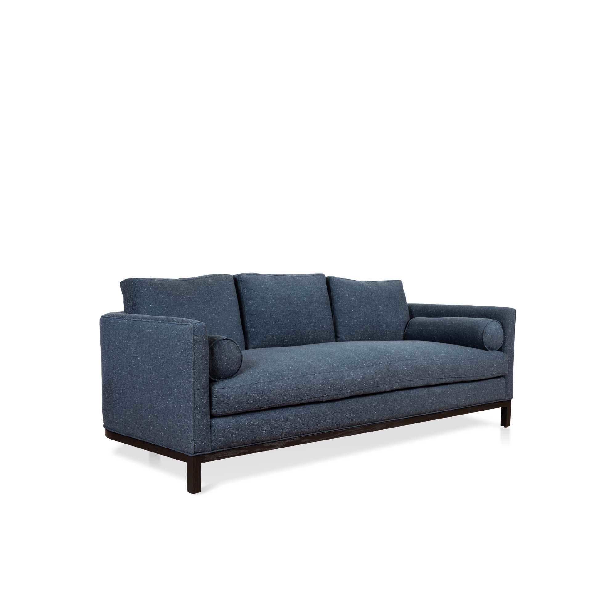 The curved back sofa is a tuxedo style sofa with curved corners and features a single down-wrapped, seat cushion with 3 down-wrapped, removable back cushions and two bolsters. The base can be made in American walnut, white oak or metal. 

The