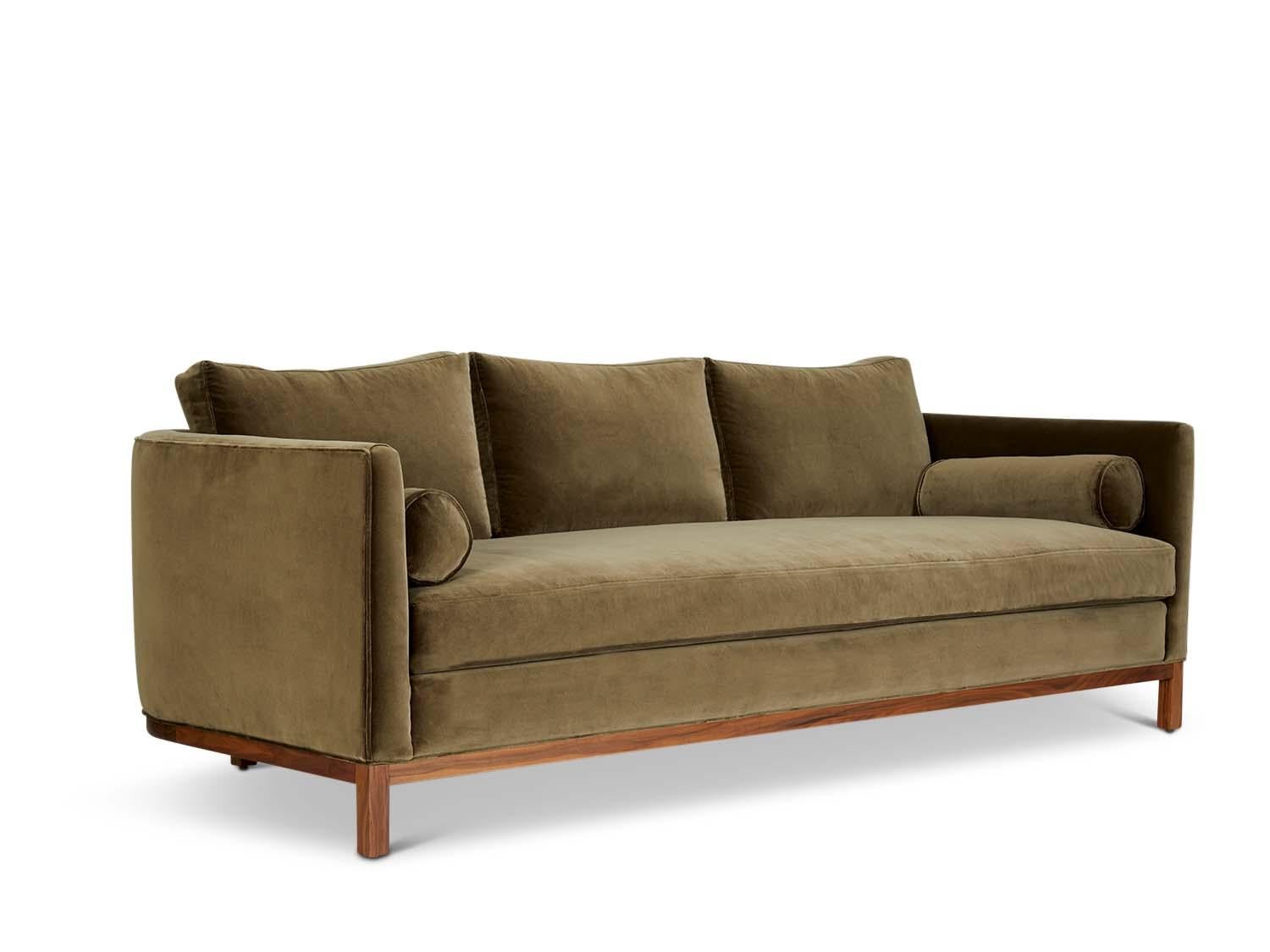 The curved back sofa is a tuxedo style sofa with curved corners and features a single down-wrapped, seat cushion with 3 down-wrapped, removable back cushions and two bolsters. The base can be made in American walnut, white oak or metal. 

The