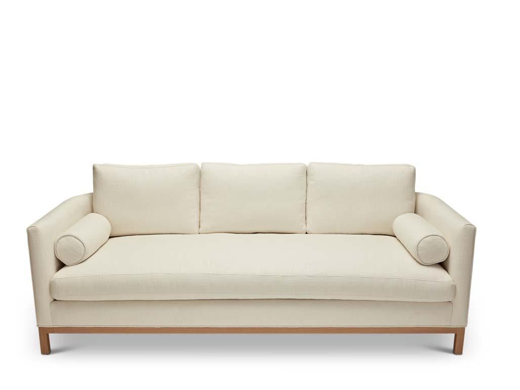 The curved back sofa is a tuxedo style sofa with curved corners and features a single down-wrapped, seat cushion with 3 down-wrapped, removable back cushions and two bolsters. The base can be made in American walnut, white oak or metal. 

The