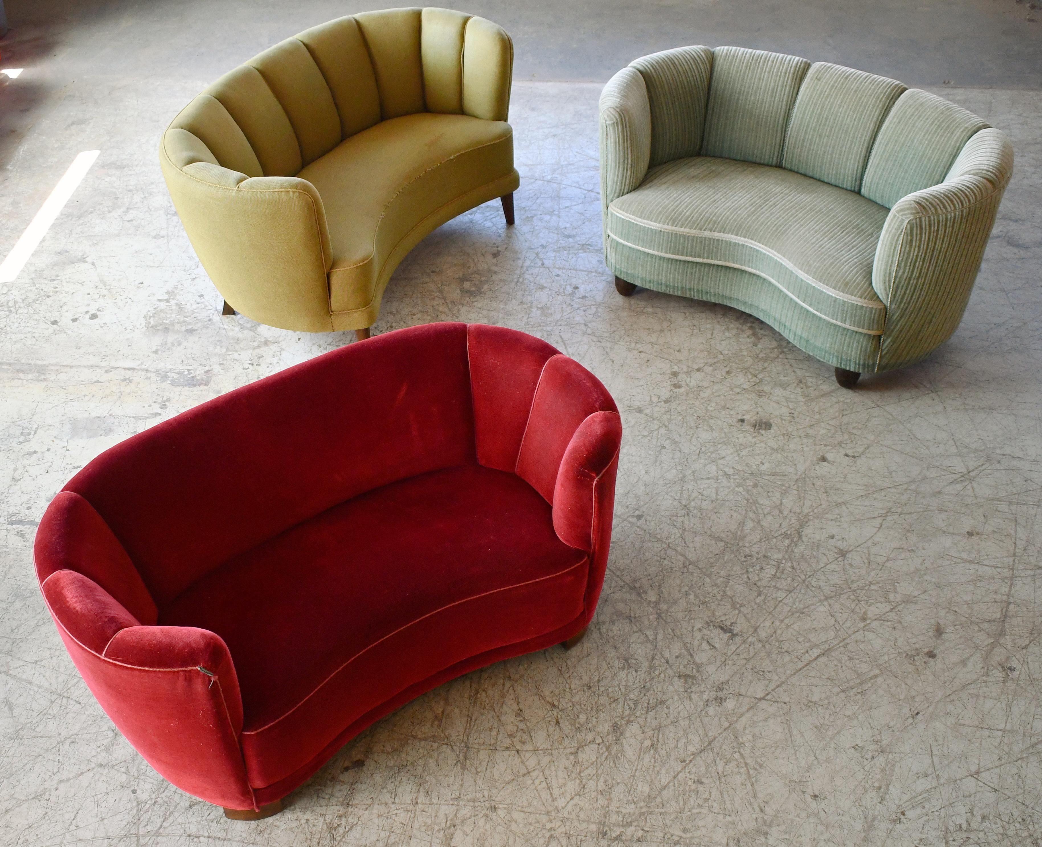 Viggo Boesen style banana shaped or curved Loveseat made in Denmark, around late 1930s or early 1940s. These small sofas will make a strong statement in any room. Beautiful round voluptuous lines and solid thick legs. The legs come in various
