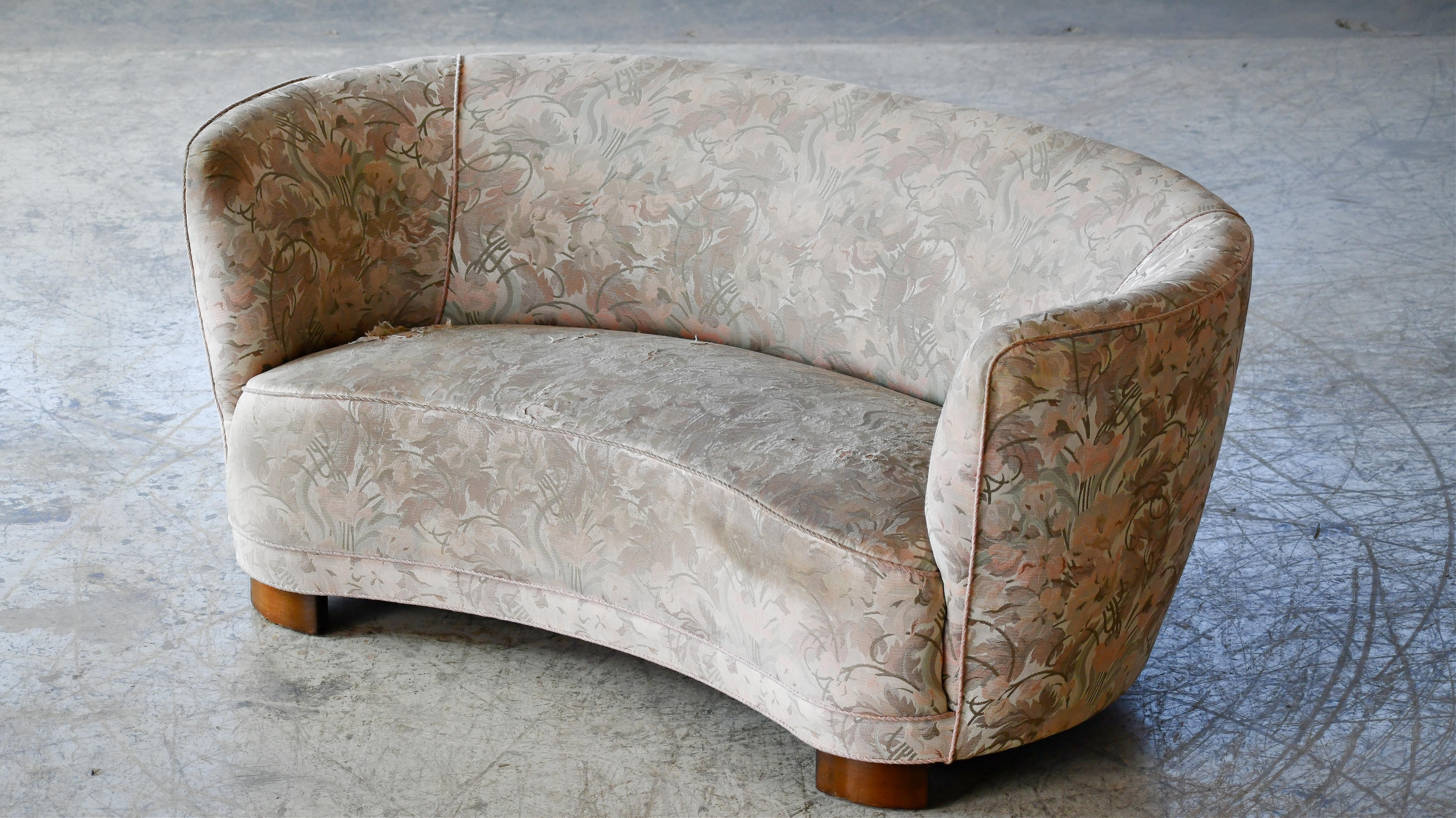 Viggo Boesen style banana shaped or curved Loveseat made in Denmark, around late 1930s or early 1940s. This small sofa will make a strong statement in any room. Beautiful round voluptuous lines and solid thick legs. The original fabric is still
