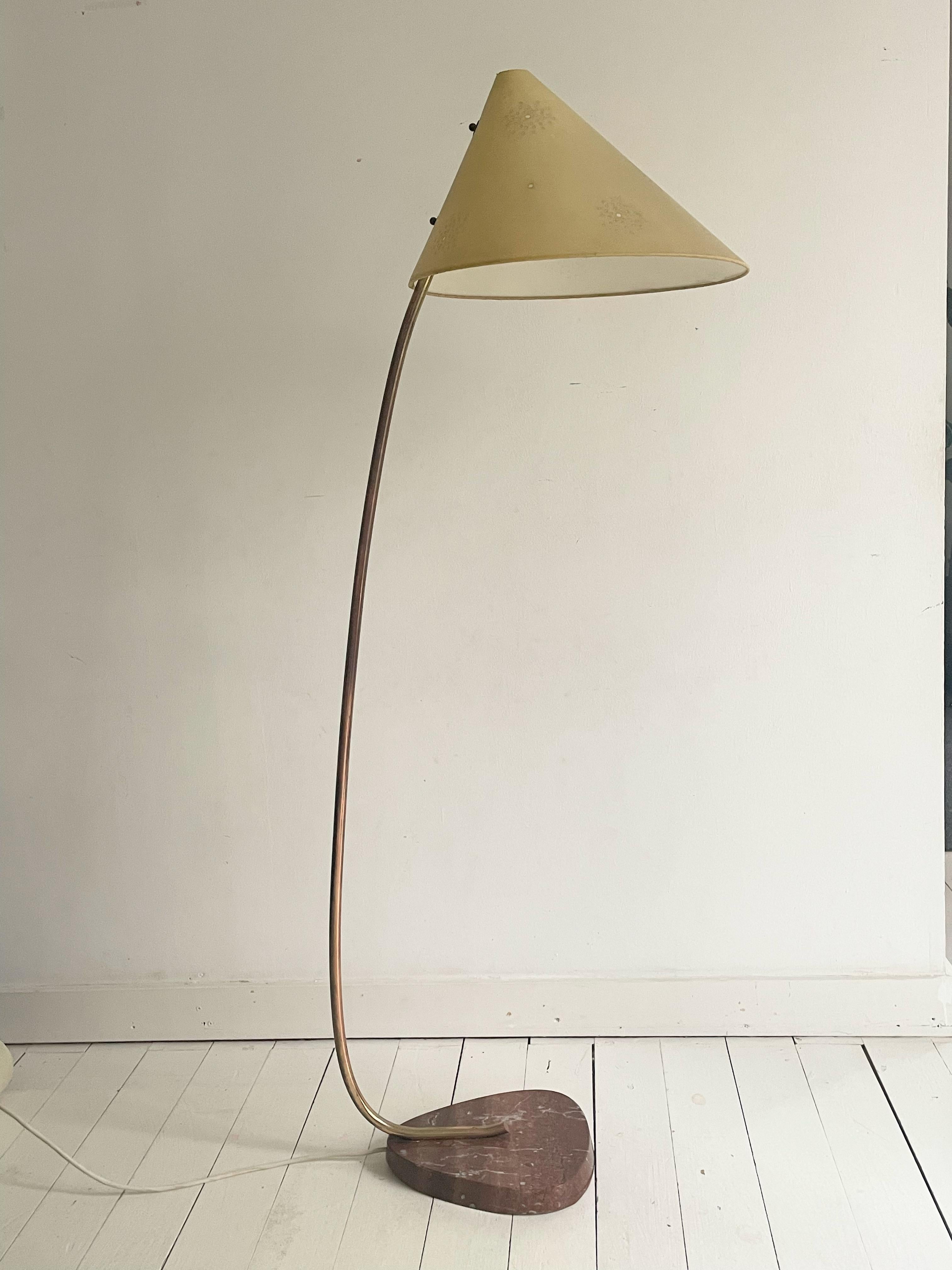 This unique type of lamp is a rare find, as it was manufactured in Austria in the 20th century. It was produced in very limited quantities in the middle of the century. Mounted on a marble base with a bent brass stem and a perforated conical shade.