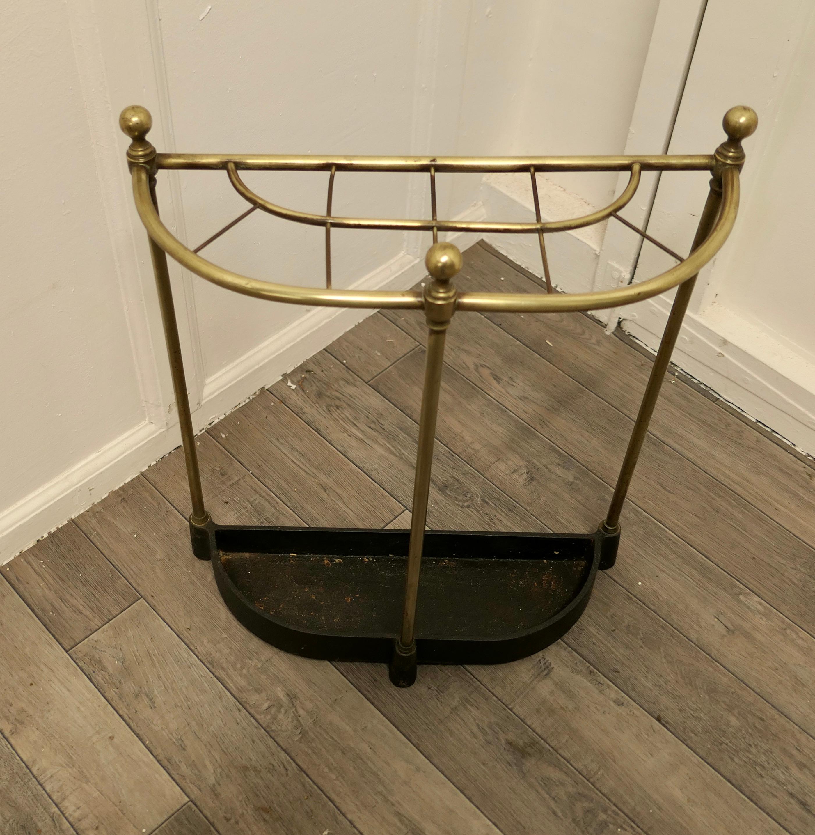 Curved brass & iron stick stand or umbrella stand

A charming piece, and it has a very unusual elliptical half moon shape, the stand is divided into 10 sections to hold either Walking Sticks or Umbrellas and topped of with brass knobs, the heavy