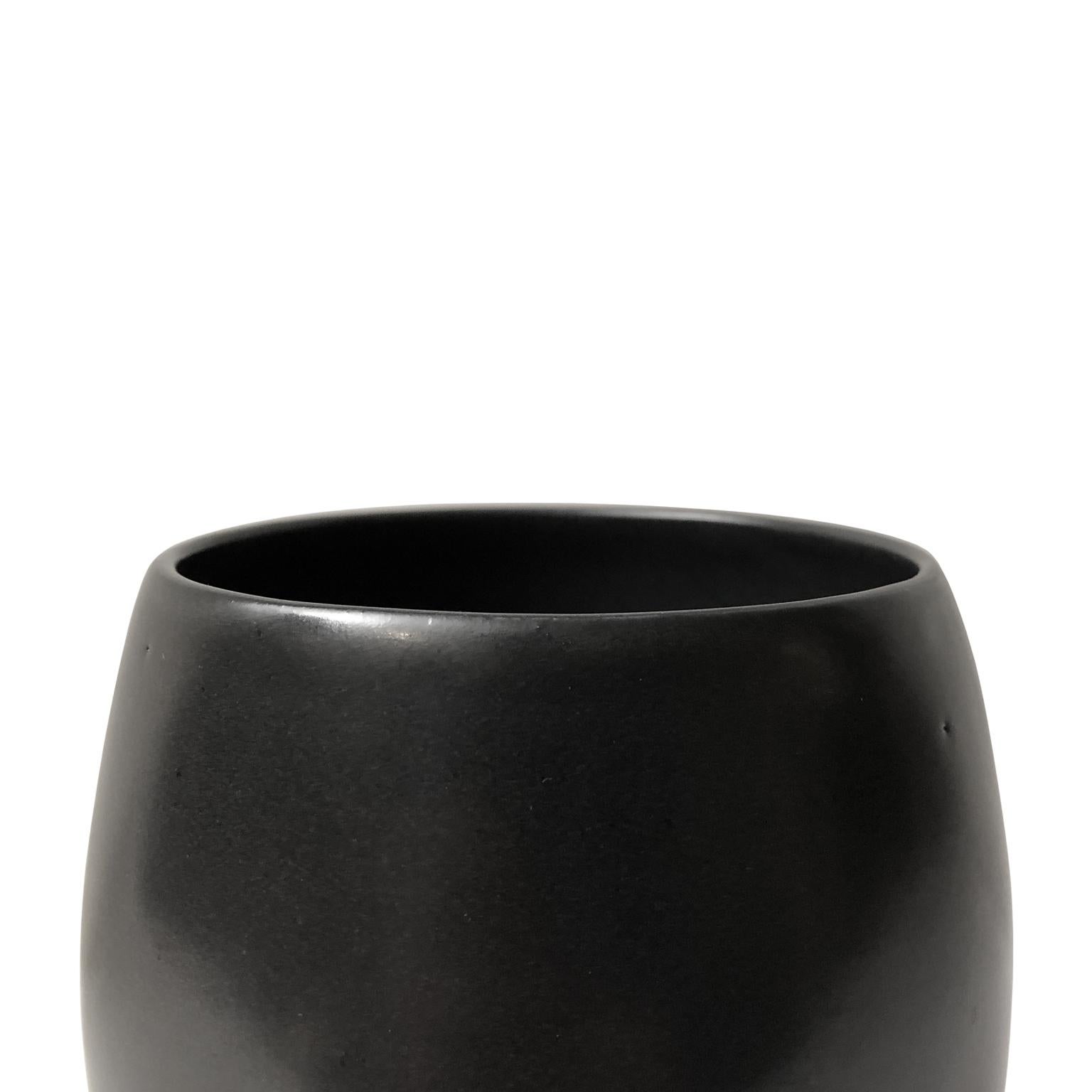 Curved ceramic vase with black lustre glaze and pointed base by Sandi Fellman, 2019.