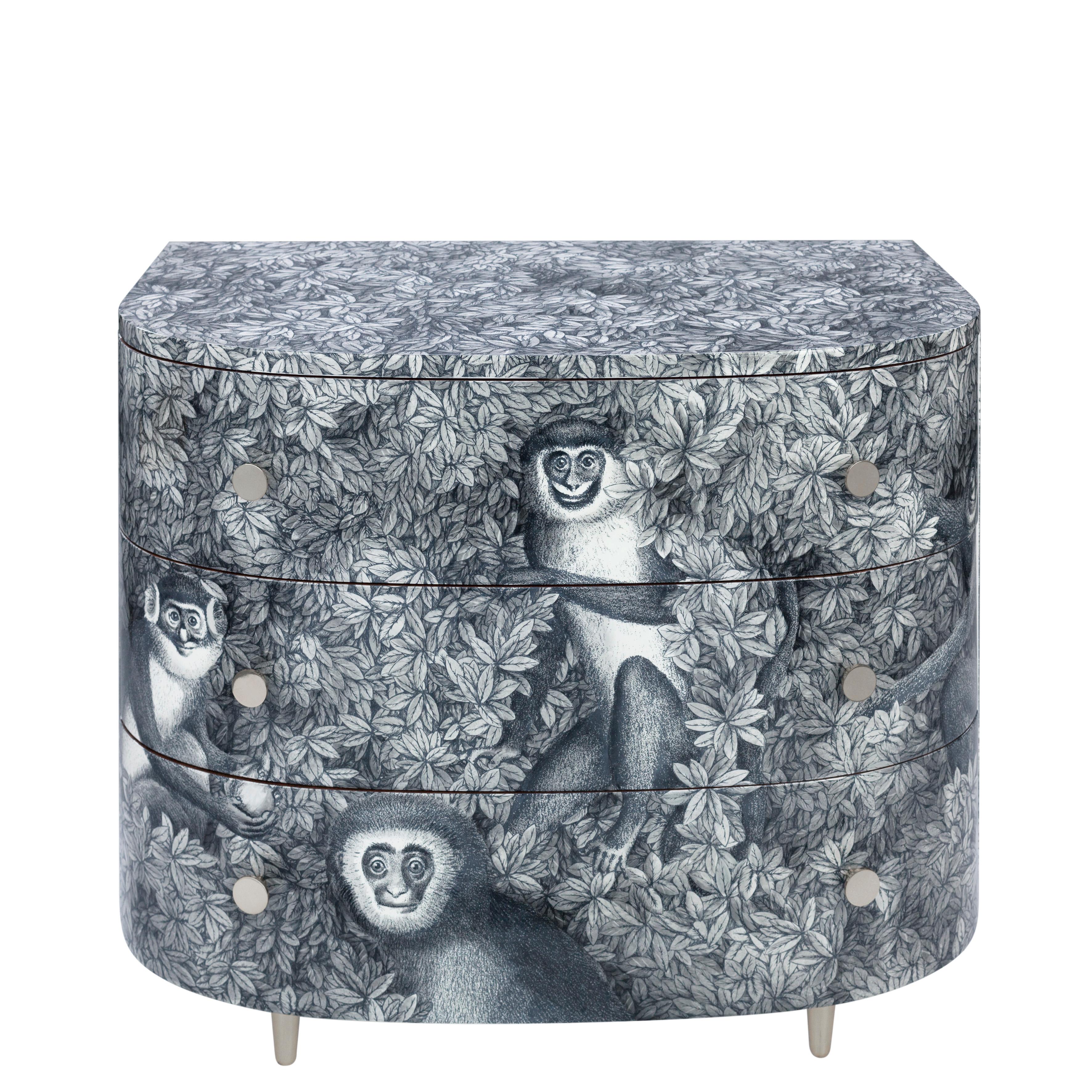 Like all Fornasetti pieces of furniture, it is handcrafted using original artisan techniques.
This corner cabinet is silk-screened by hand, hand-panited and covered with a smooth lacquer.

The decoration depicts the iconic Fornasetti monkeys on a