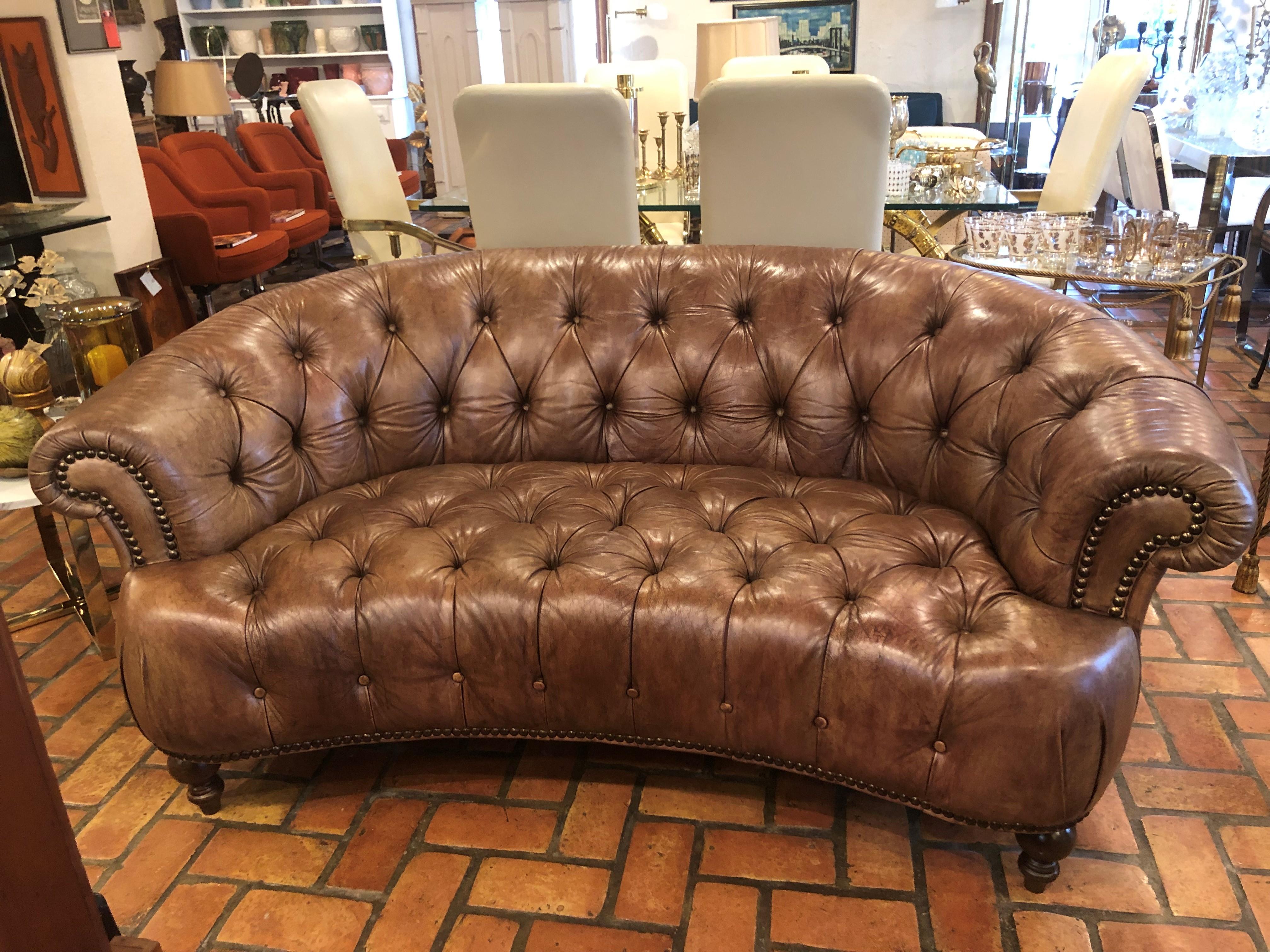 Curved lightbrown Italian leather chesterfield sofa. Sumptuous tufted button back curved sofa. The classic design for any living room or study. This delicious color and design is a staple for any traditional home. Fabulous weathered patina to this