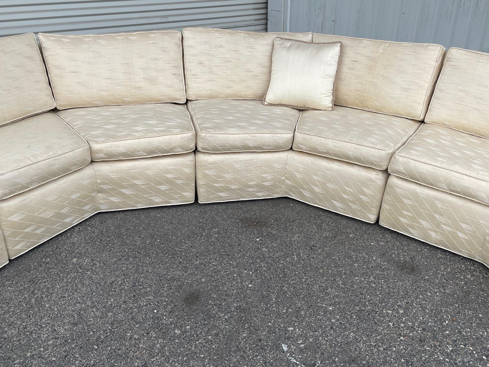 Large Hollywood Regency sofa in the style of Milo Baughman features five pieces in a geometrical curved form. Maker's label is no longer present. For transport purposes, each section measures approx. 56