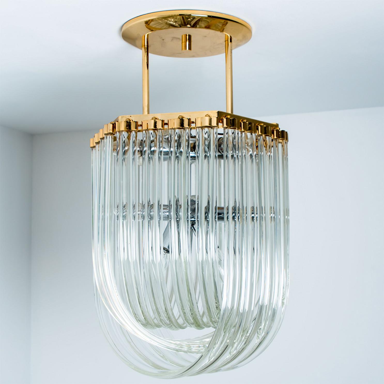 Beautiful chandelier featuring several sides of multiple long curved crystal clear glass 
