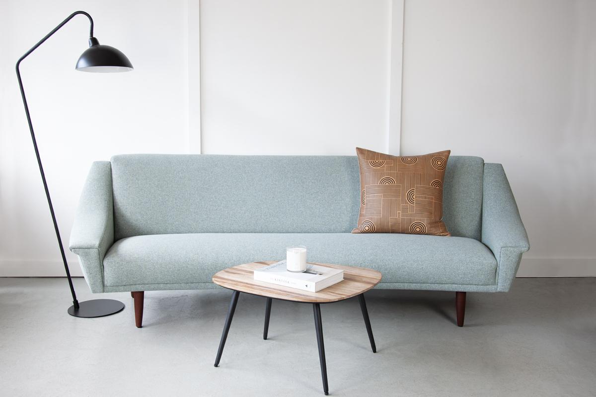 A stunning Danish sofa, designed by Georg Thams for Vejen Polstermøbelfabrik. This sofa has a wonderfully welcoming curved profile and sweeping armrests with the typically mid-century winged detail. Newly upholstered in a soft, easy-care linen