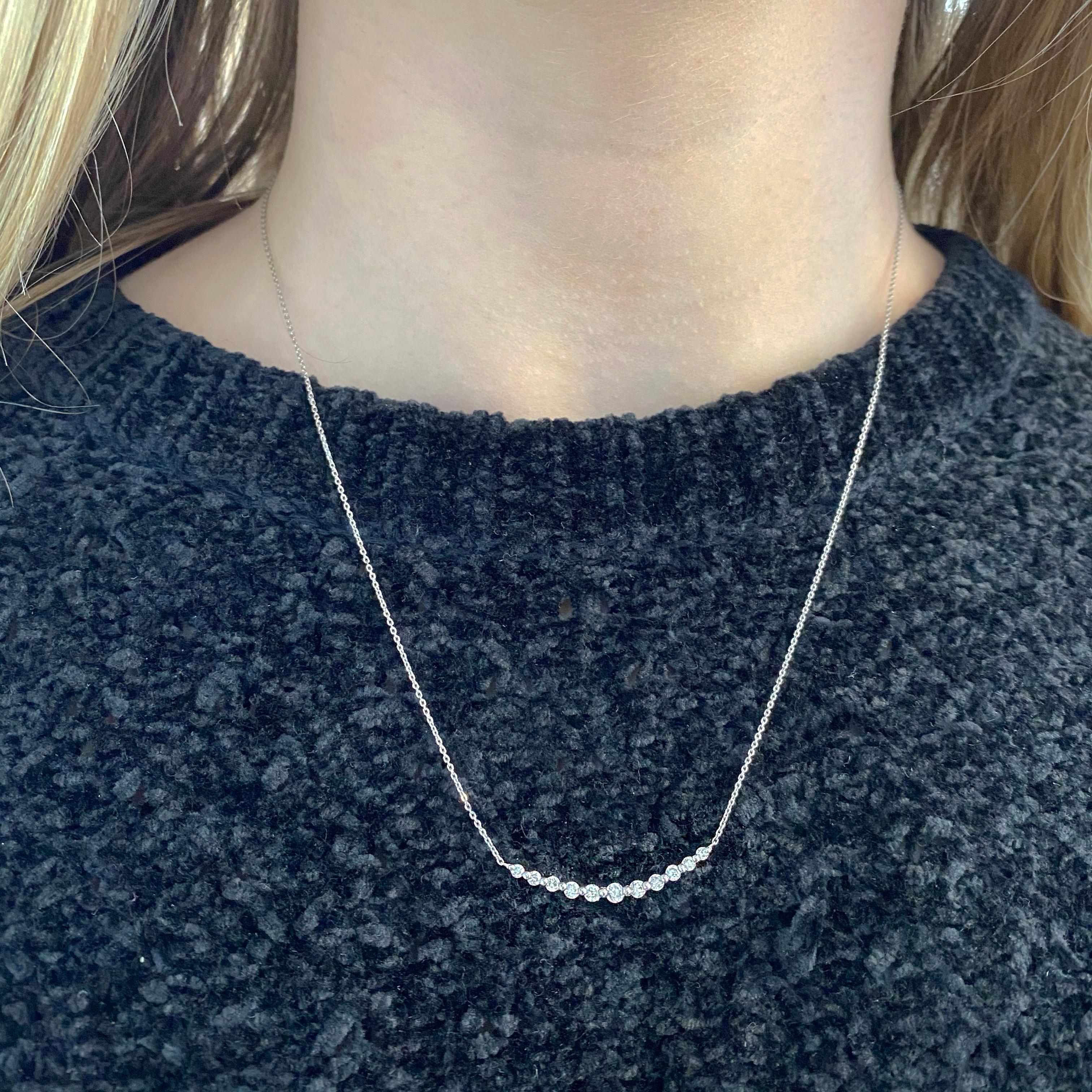 The details for this 1/2 carat, .50 carat smile bar necklace are listed below:
Metal Quality: 18kt White Gold
Pendant Style: Modern
Diamond Number: 11
Diamond Shape: Round Brilliant
Diamond Total Weight: .50 Carat
Measurements of Pendant: 34 x 2.76