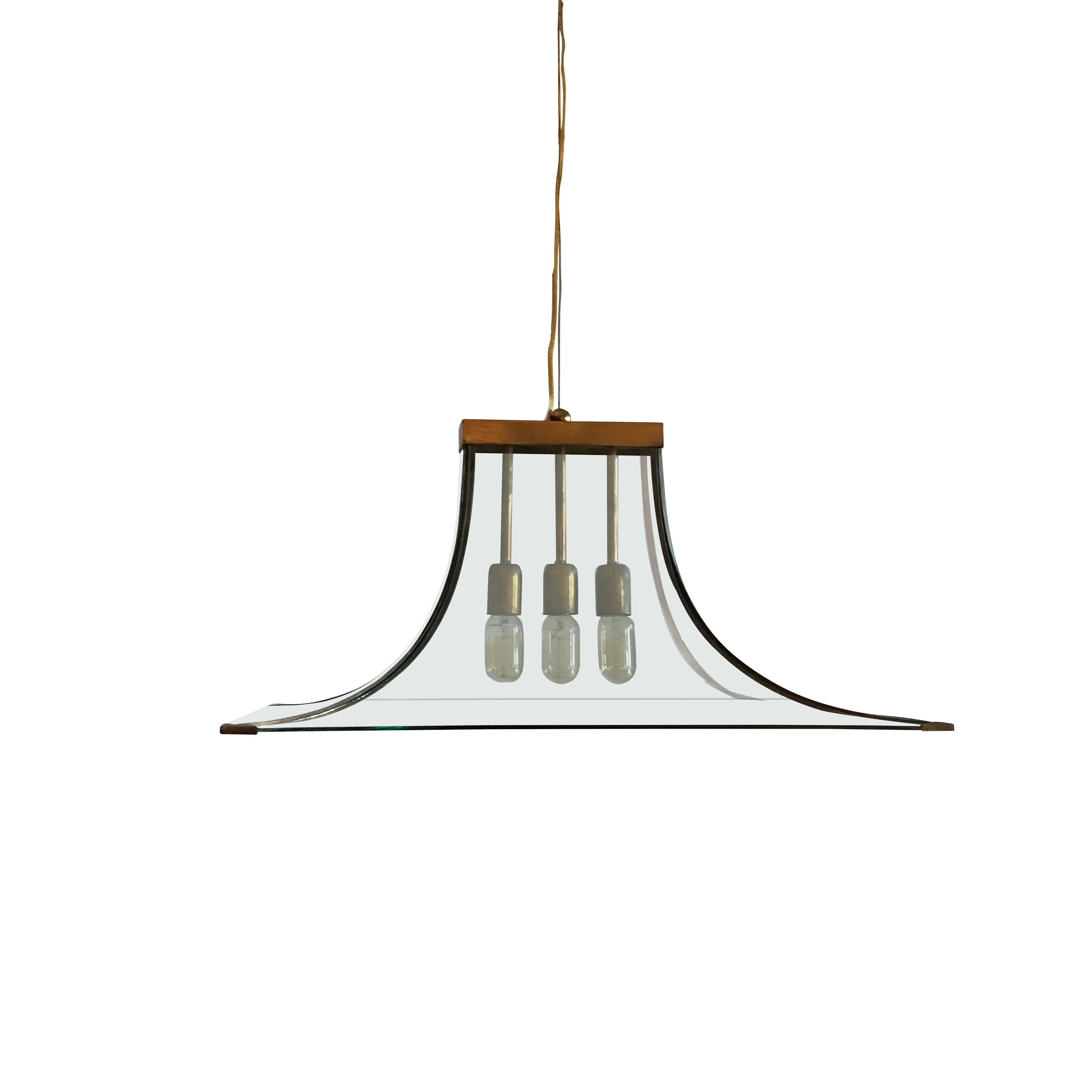 Rectangular curved clear glass chandelier with brass trim.
Three brass sockets and brass strips at the four edges.
Canopy is included.
Recently rewired.