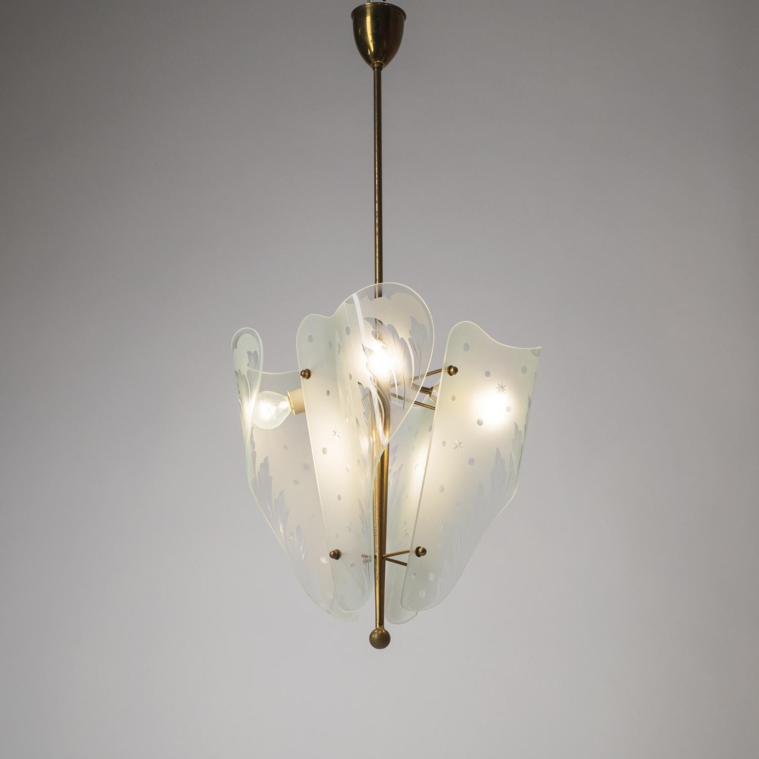 Rare midcentury Italian chandelier from the 1950s. Highly intricate glass work with four large organically shaped glass diffusers that are curved, acid-etched and cut with a decor of stars, dots and floral elements. Very nice original condition with