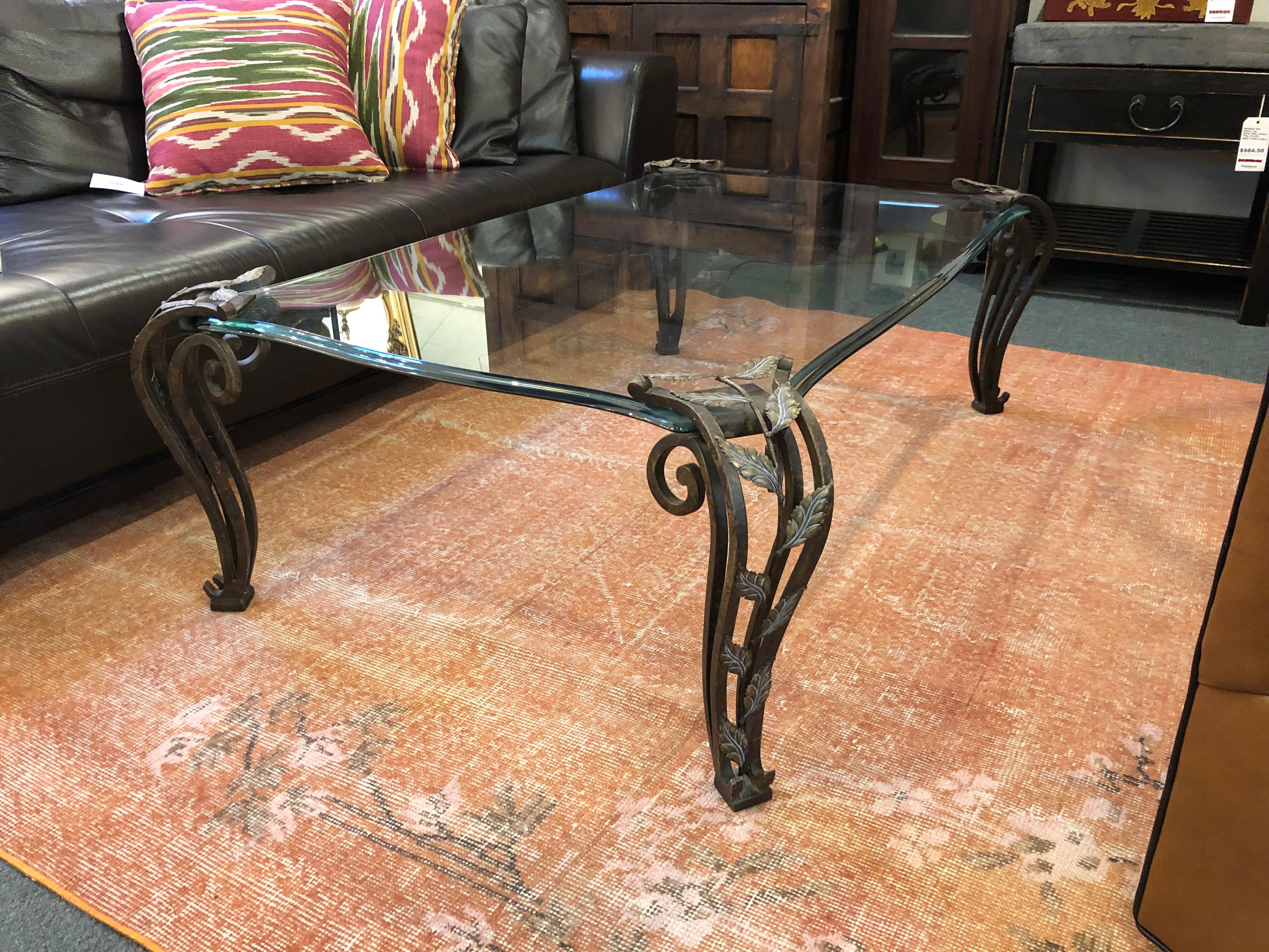 Design Plus Gallery presents a unique cocktail table by Thomasville. Grand in scale and substance, this table is made to complement the most luxurious living areas. The verdigris bronze leaf embellished cast legs are topped by a ½” thick glass top