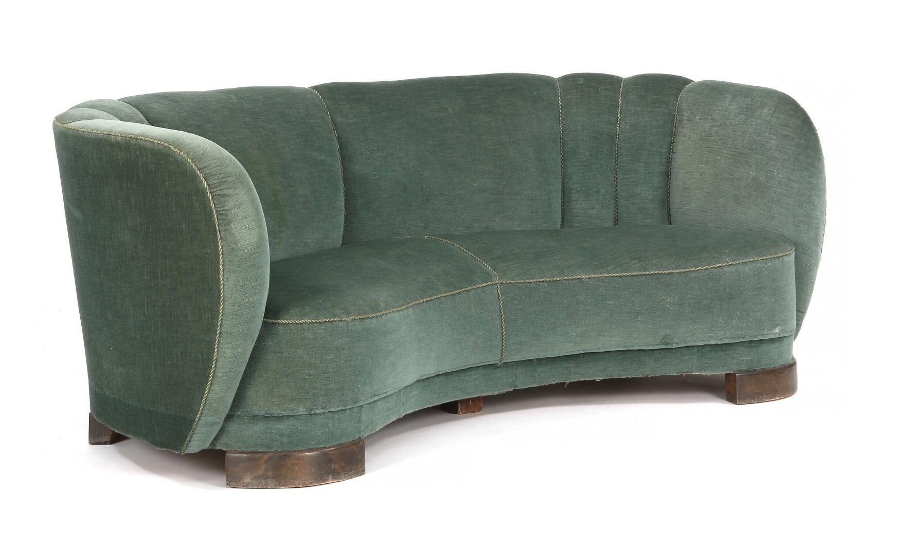 Banana shaped curved sofa in the style of Viggo Boesen and Fritz Hansen, made in Denmark, 1940s. Some wear to green velvet fabric.

 