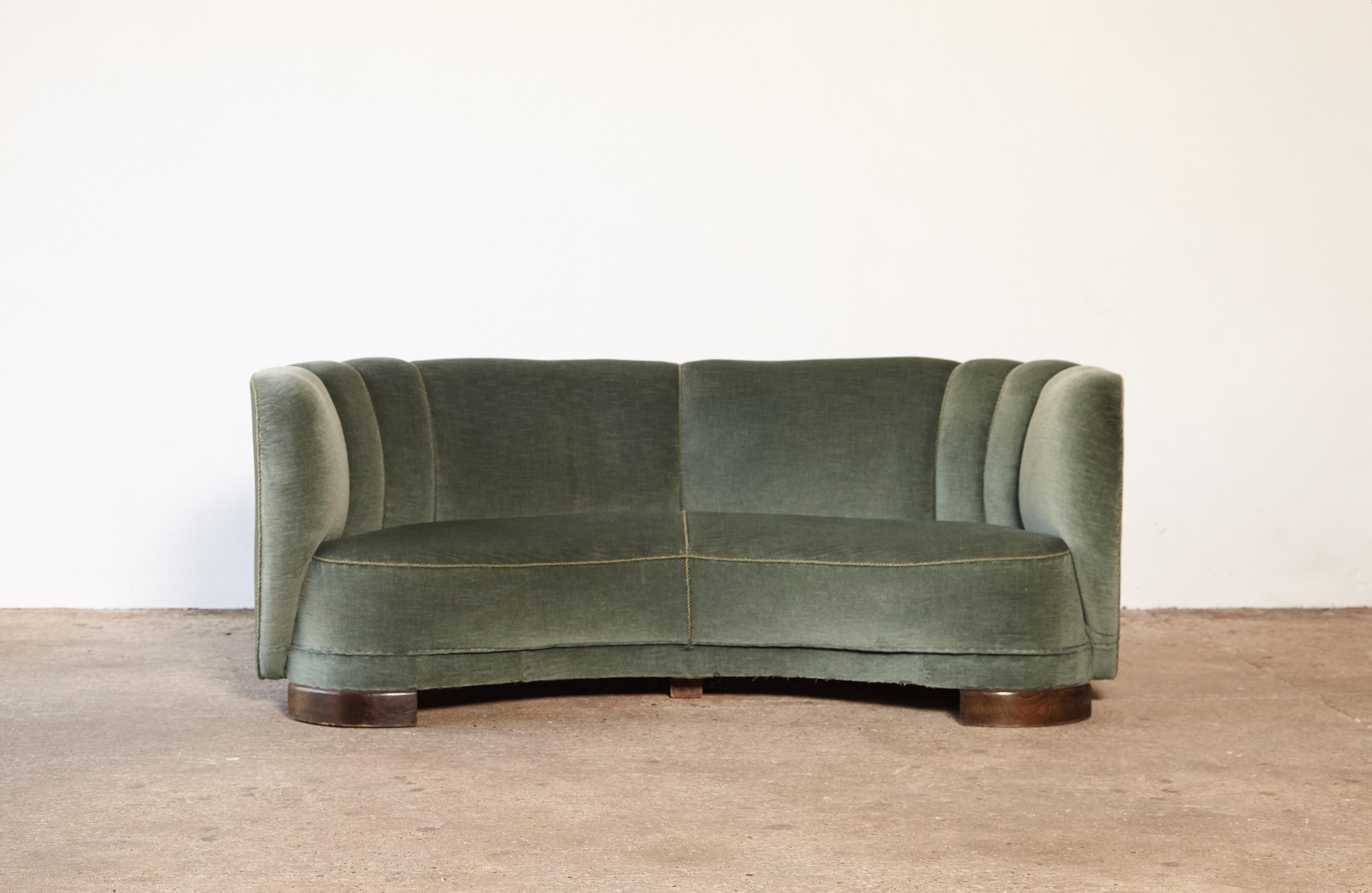Banana shaped curved sofa in the style of Viggo Boesen and Fritz Hansen, made in Denmark, 1940s. Some wear to piping and green velvet fabric on the back.

 
