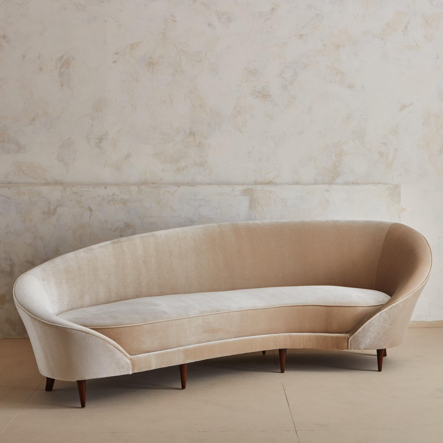 An elegant mid century Italian sofa sourced in Northern Italy. Upon arrival to us in Chicago, our team fully restored this piece including new foam and a beautiful champagne hued velvet.