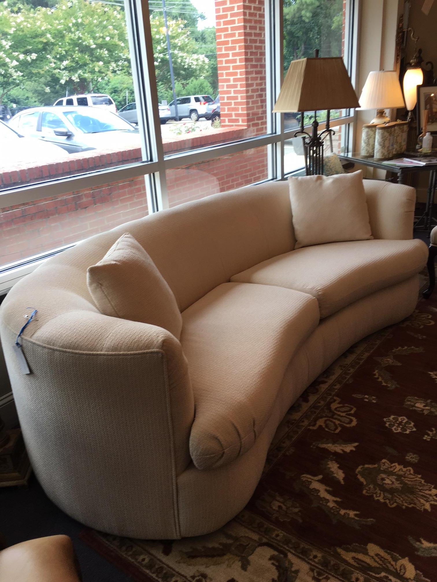 This beautiful sofa is in excellent condition. Featuring curved arms and back, the flow continues with a gentle curve to the front of the sofa. The fabric is a luxurious silk blend weave in a cream shade. it is flawless.