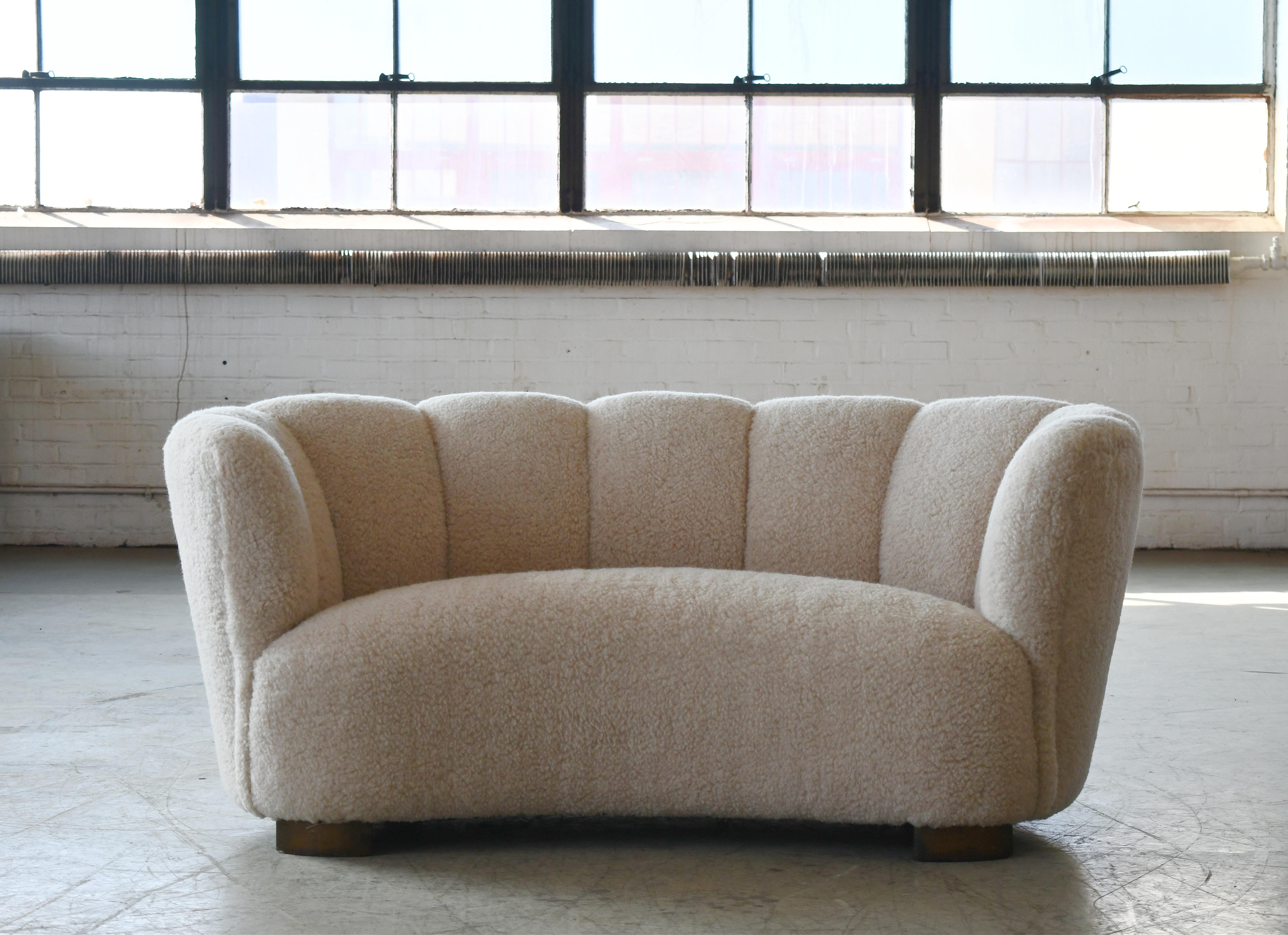 Banana shaped Viggo Boesen style curved two-seat sofa or loveseat made in Denmark in the 1940s. This sofa will make a strong statement in any room. Beautiful round lines and iconic block feet feet normally associated with Viggo Boesen. Fully