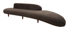 Curved Midcentury Ottoman Reupholstered in Charcoal Faux Shearling