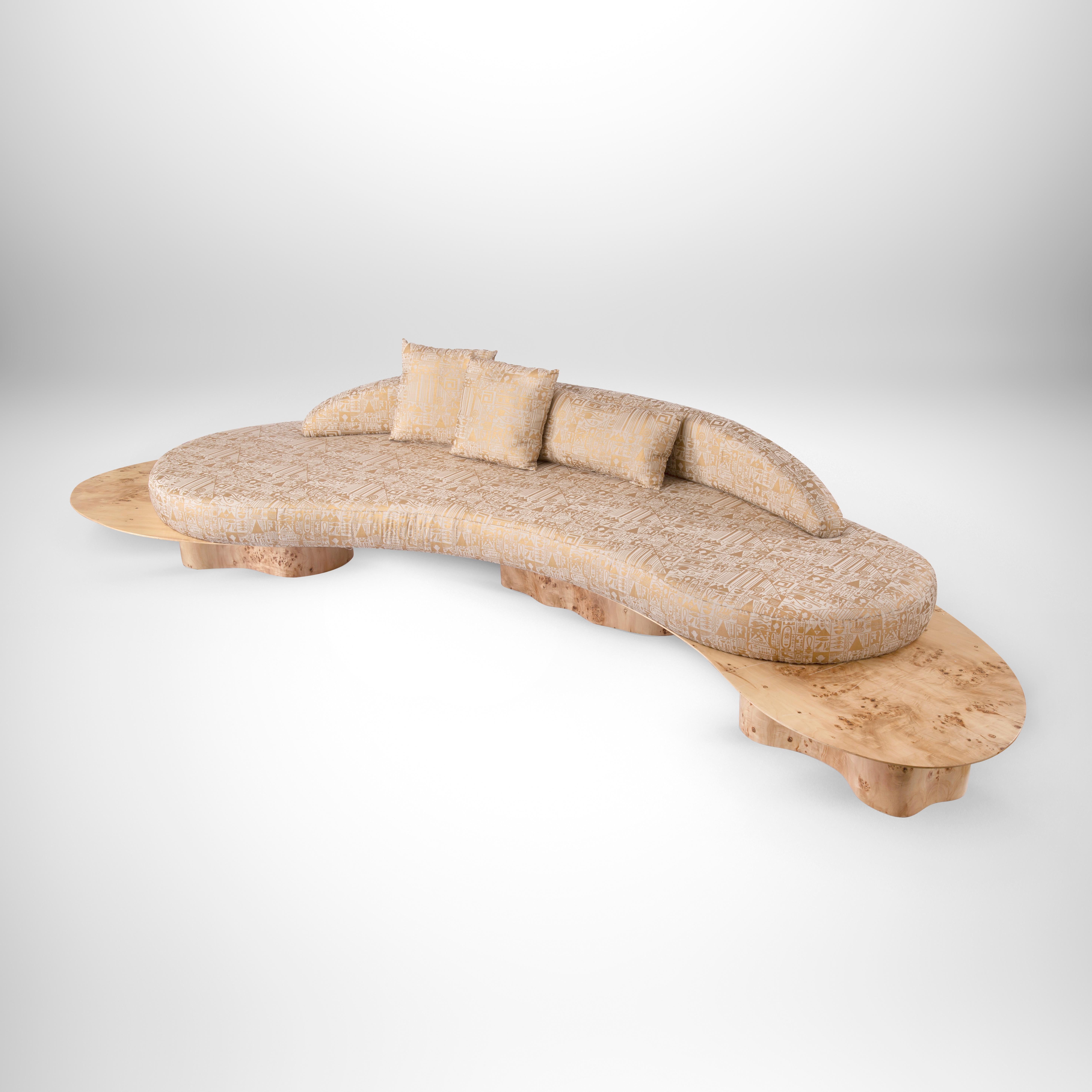 Curved organic-shaped sofa with rare apple rind and golden Pharaonic fabric.
To eternity and beyond on contemporary one of a kind design. This organic shaped sofa curves invitingly like welcoming arms ushering you to sit and relax. The apple rind