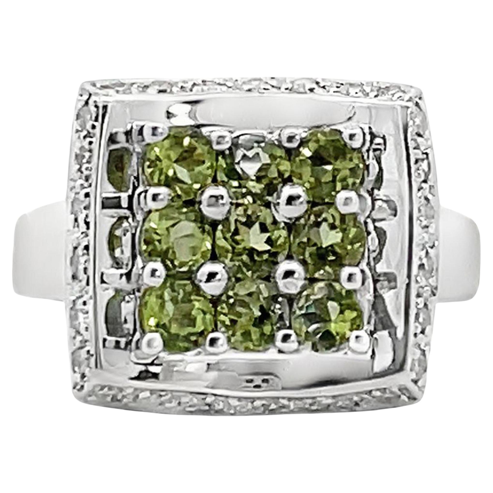 14K white gold ring with round peridot weighing 1.09 carats total and diamonds weighing 0.18 carat total.

- Finger size 7, can be sized up or down by up to two sizes