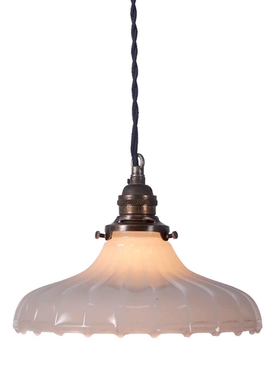 These softly curved pendants are a Classic. They feel at home with any style decor. This example is an extra heavy pattern with a clam broth glass. The lamps are priced per so you can buy just one or the collection.