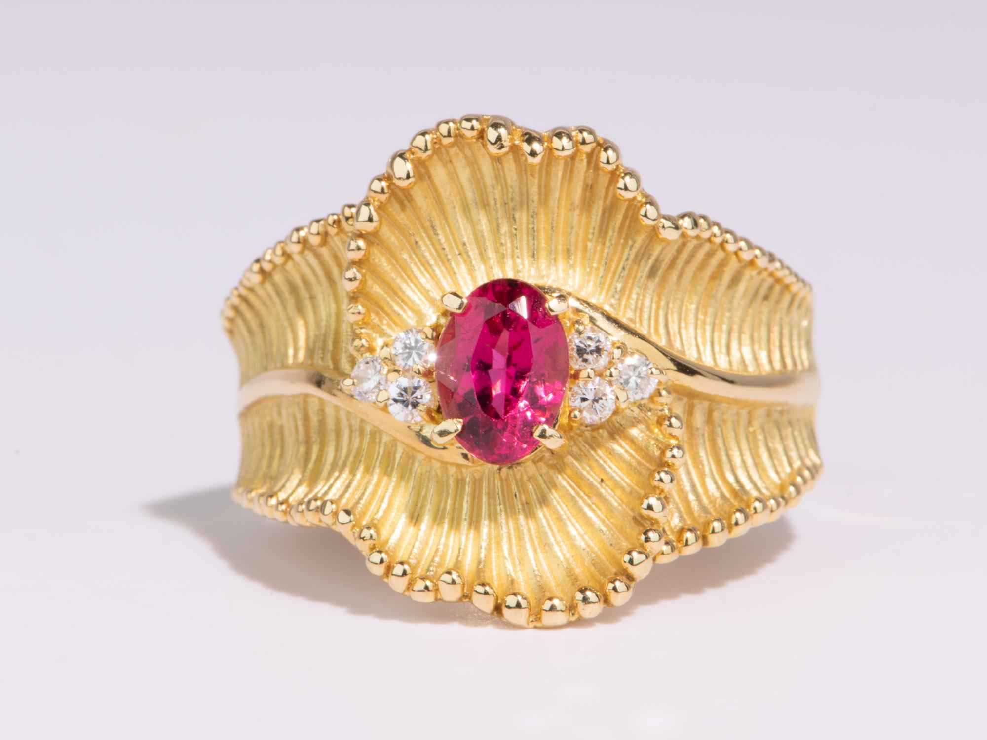 Fall in love with this bold 18K Gold ring featuring a bright pink tourmaline rubellite gemstone in the center, caressed by a bold curved ribbon design. Made from a hand-carved wax design, this eye-catching ring is the perfect statement piece to wow