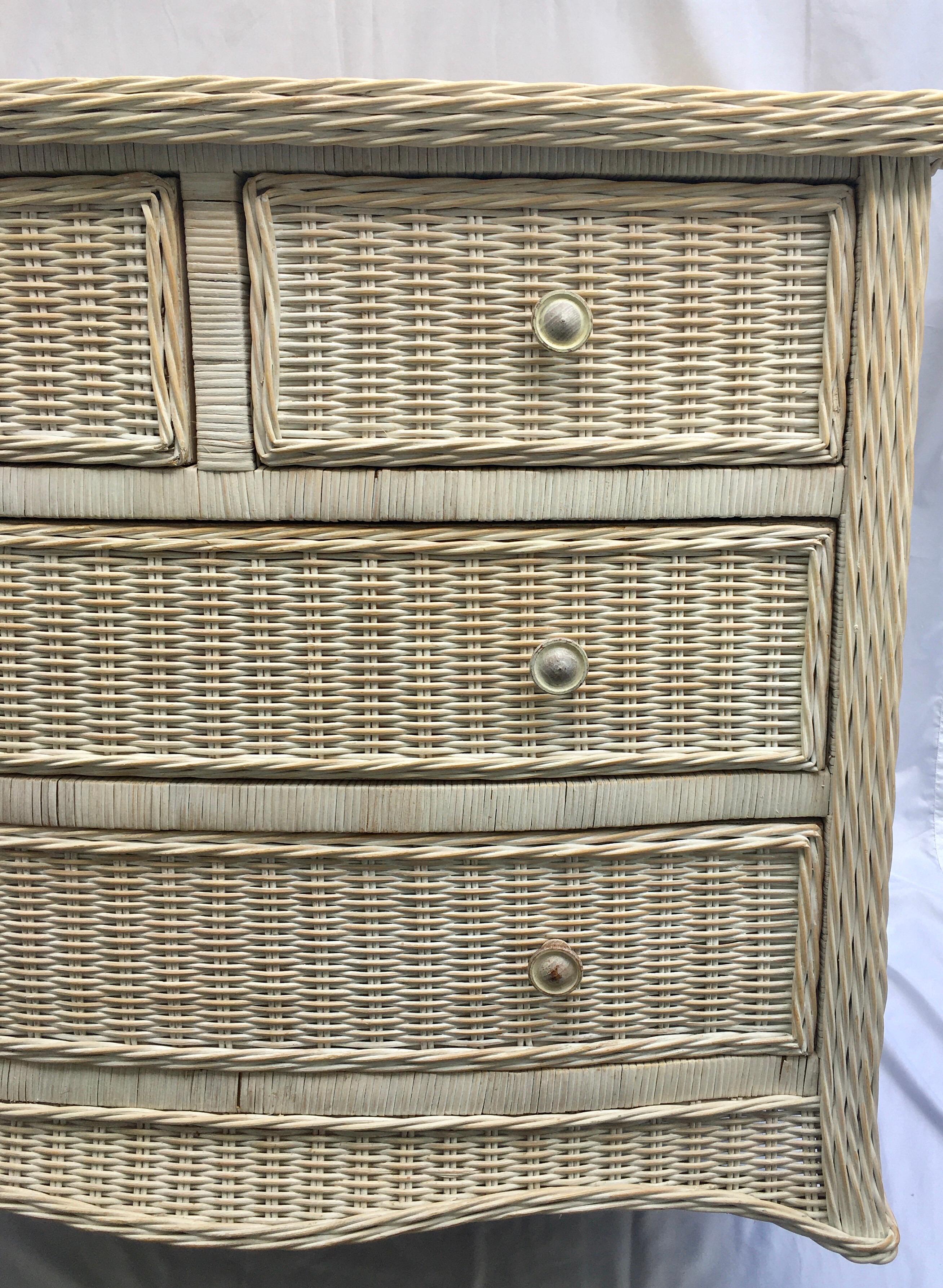 Sculptural washed wicker storage chest of drawers. This textural woven wicker cabinet features a curved serpentine draped front and four easy glide drawers. In the style of Henry Link.
