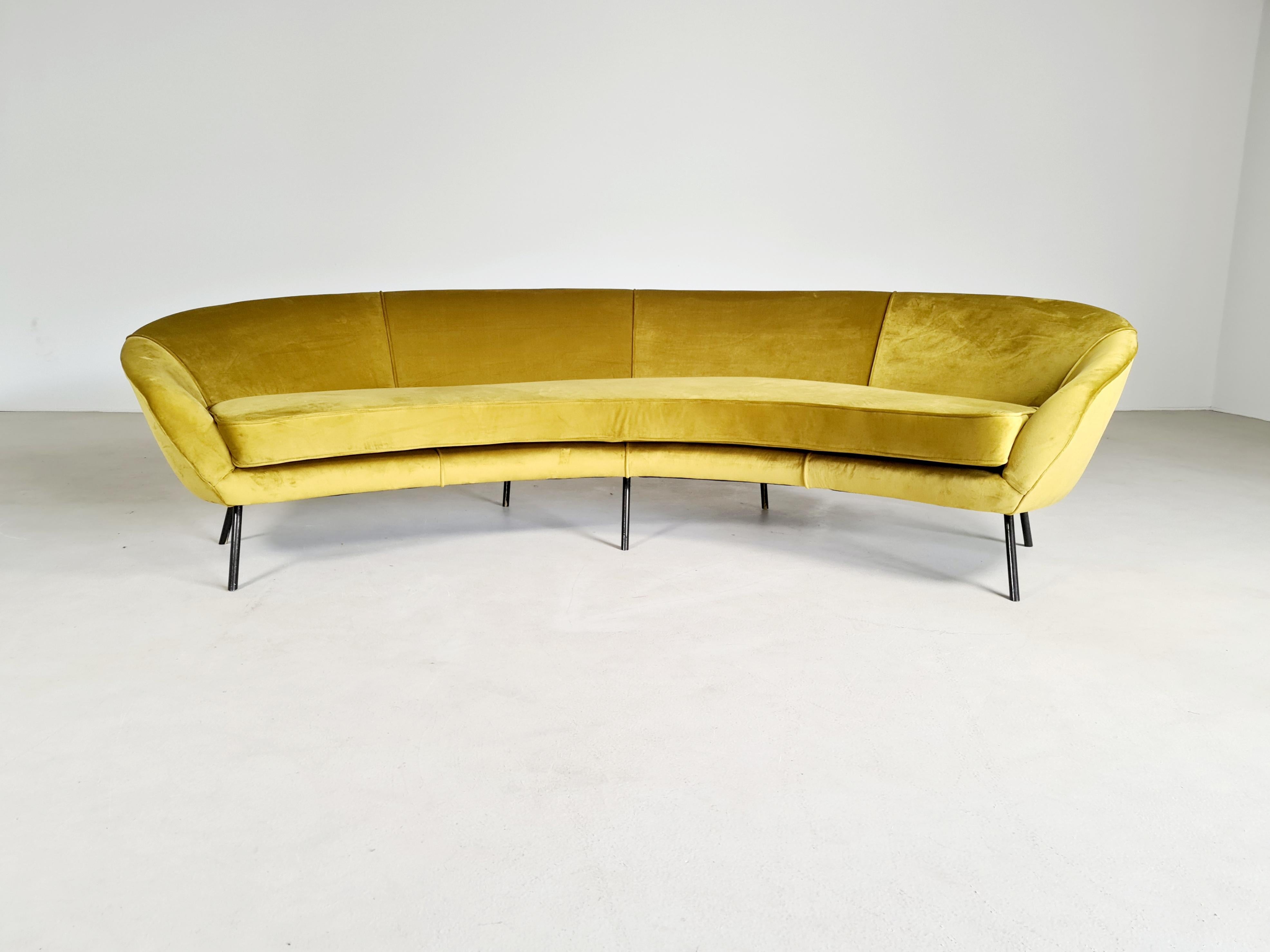 A large Italian curved asymmetrical sofa in the style Ico Parisi or Federico Munari, on steel feet, and newly upholstered in green/gold velvet.