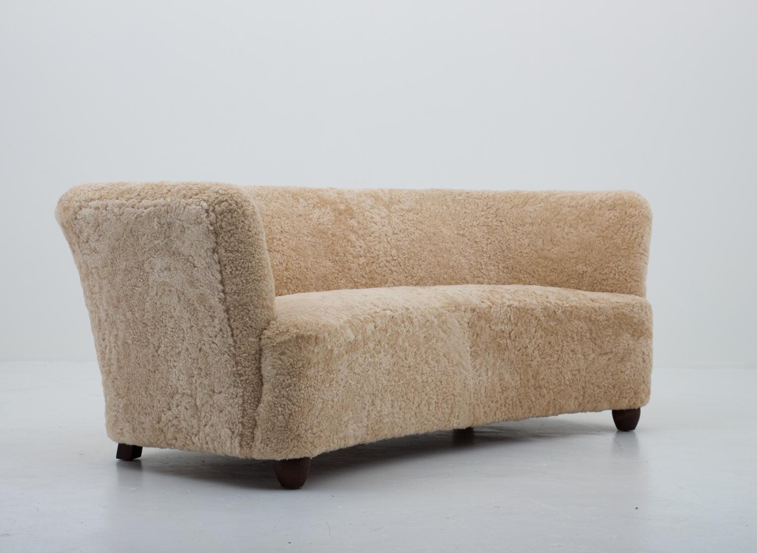 Stunning 3-seat sofa manufactured in Denmark, 1940s.
This organically shaped sofa is constructed with a very high sense of quality.
Since the backrest is less curved than the front, it would fit against a wall as well as stand free. Its quite