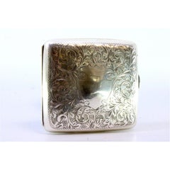 Curved silver case with plant motifs around monogram and gold interior