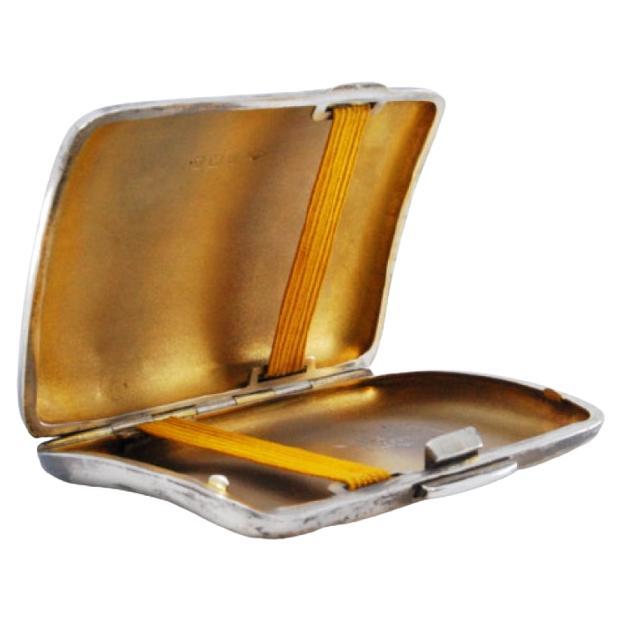 Curved silver cigarette case w/ guilloche engraving, gold interior
hinged lid