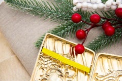 Curved silver cigarette case with engraved wreaths around monogram