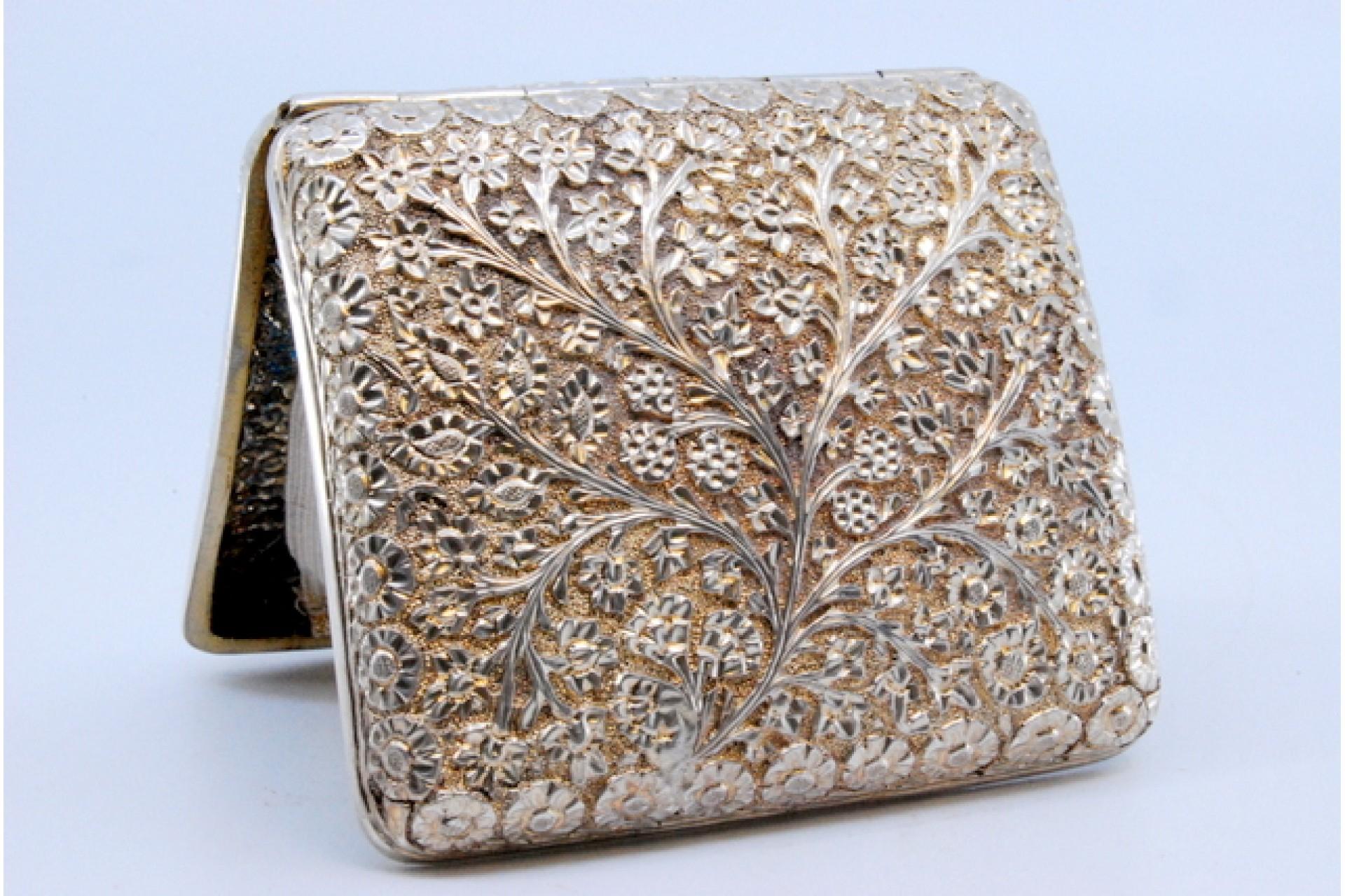 20th Century Curved silver cigarette case with flower and branch reliefs For Sale