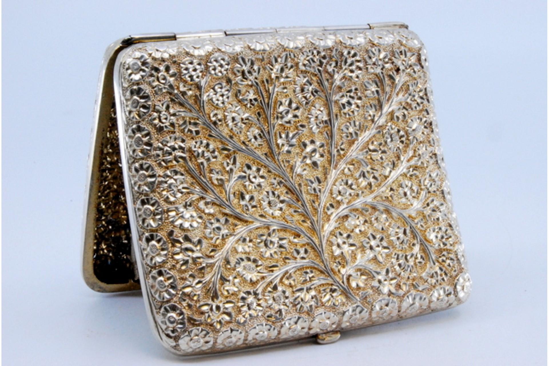 Silver Curved silver cigarette case with flower and branch reliefs For Sale