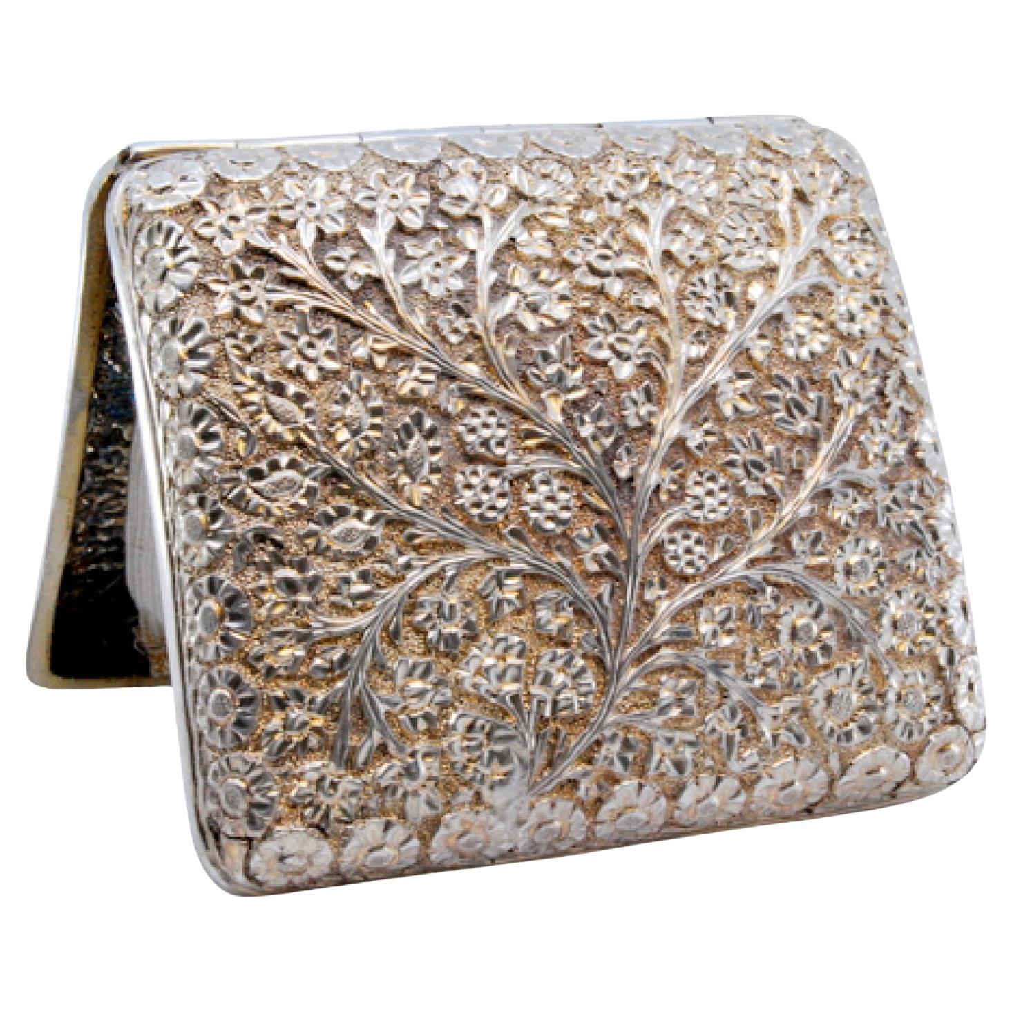 Curved silver cigarette case with flower and branch reliefs For Sale