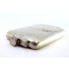 Curved silver pocket whisky flask