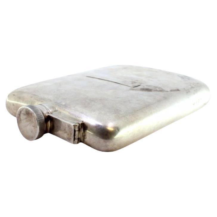 Curved silver pocket whisky flask