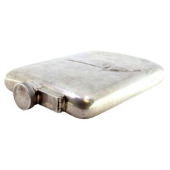 Curved silver pocket whisky flask