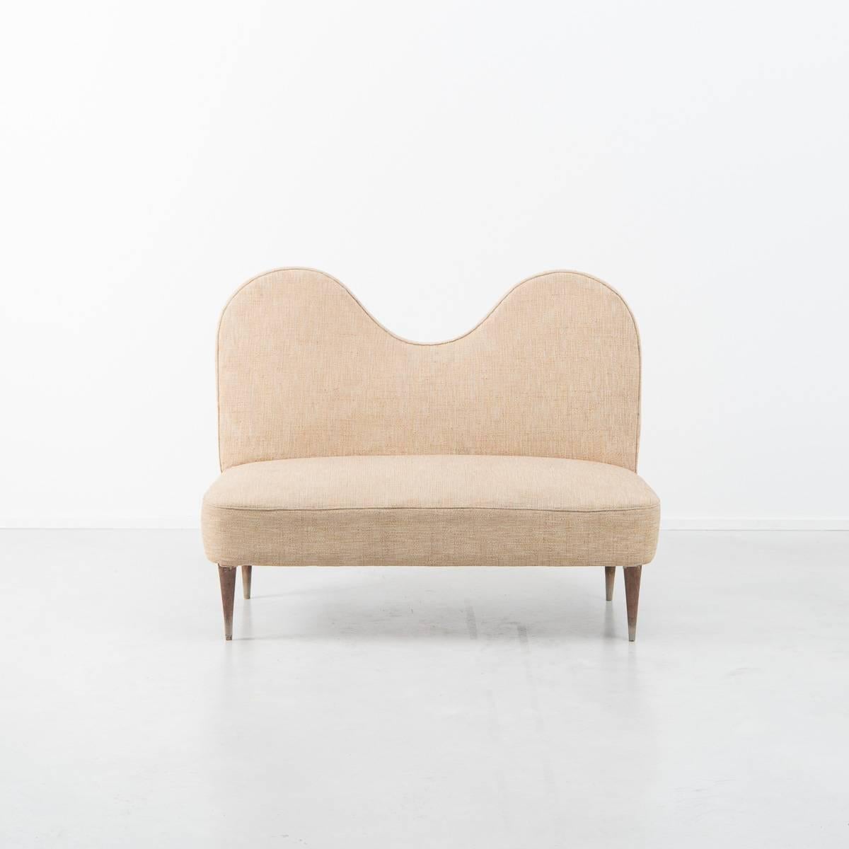 This cute curved upholstered sofa really has a load of playfulness to it. Sat on four tapered wooden legs and featuring an exaggerated curved back rest, it beautifully distils key aesthetics featured within 1950’s Italian design.

The design is