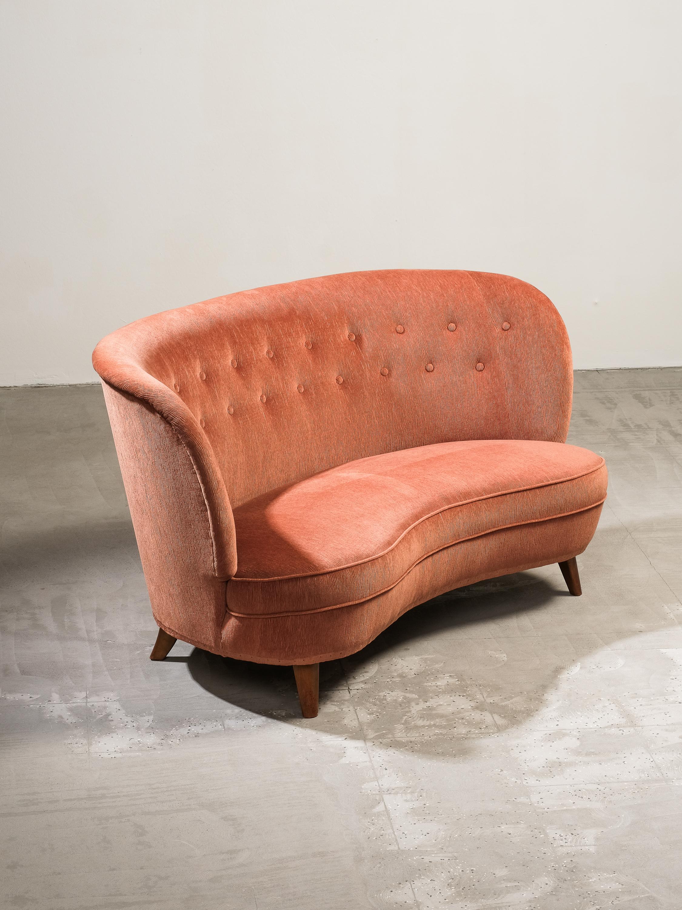 Carl-Johan Boman for Oy Boman AB rare loveseat/compact sofa with elegantly curved back and tapering stained legs, Finland, 1940s. This exquisite sofa has a classic Scandinavian Modern form including beautiful curved back extending gently into curved