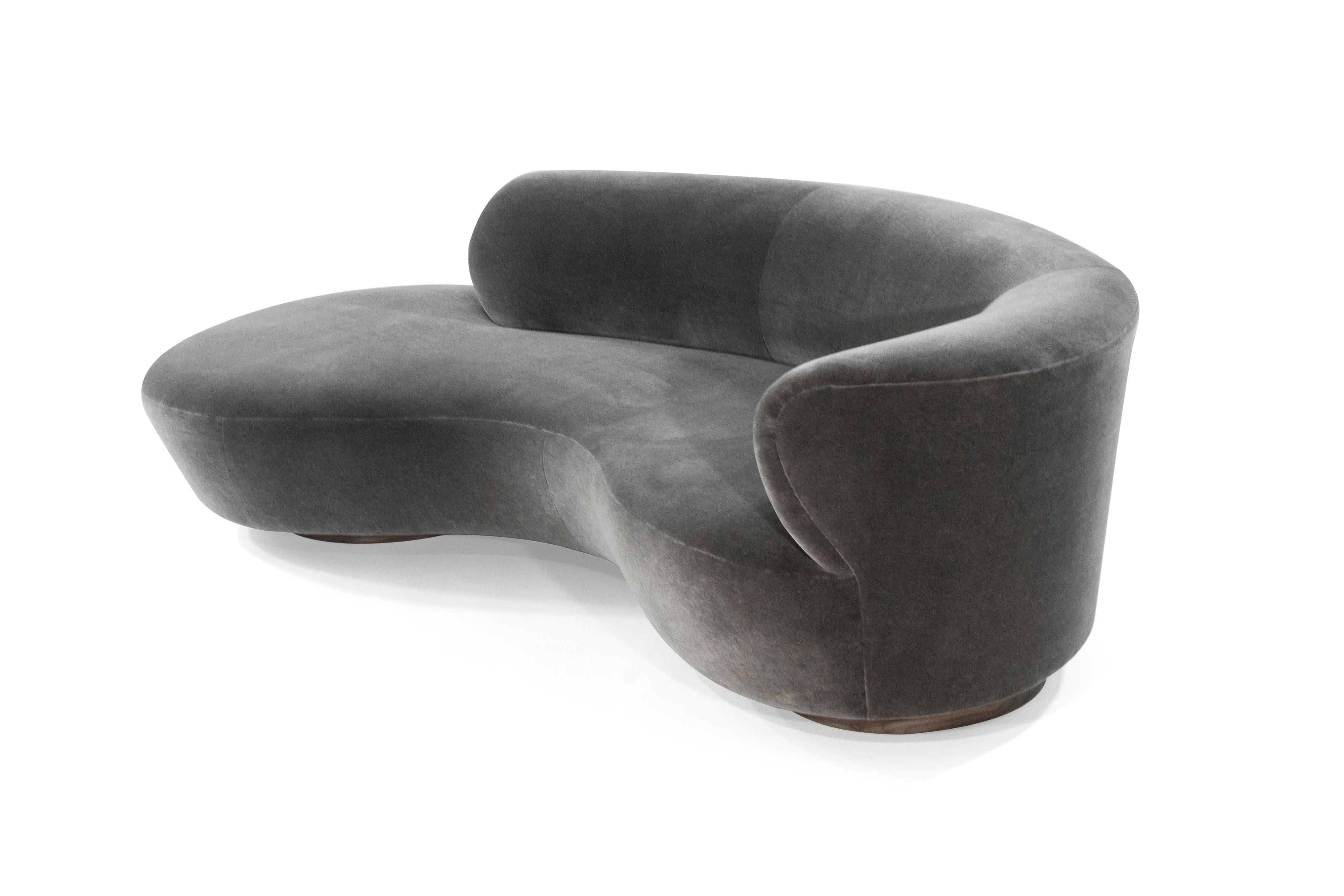 Rare curved sofa designed by the late Vladimir Kagan for Directional, circa 1970s. 

Newly upholstered in grey mohair, walnut platforms fully restored.