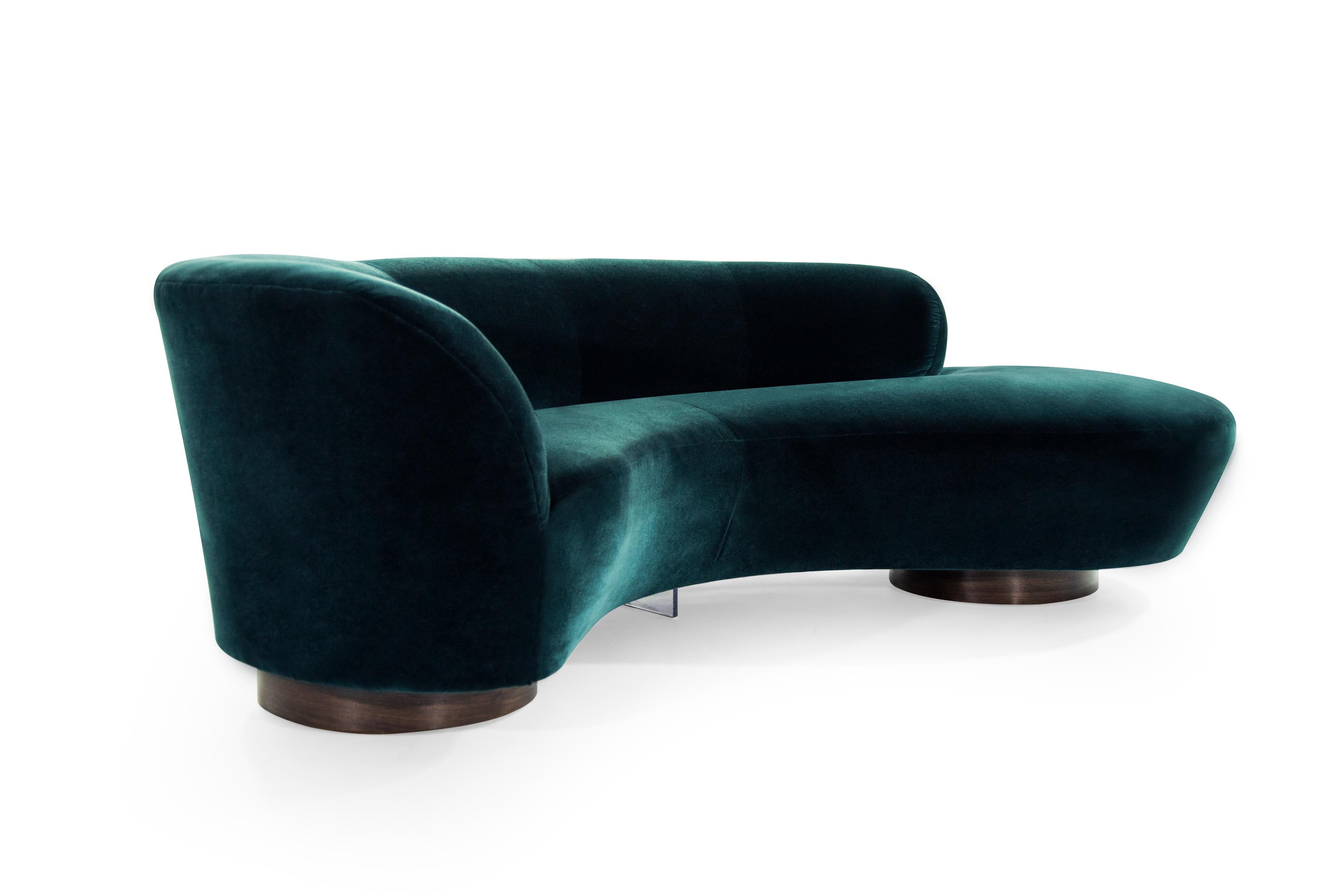 Rare serpentine sofa designed by the late Vladimir Kagan for Directional, circa 1970s. This rare example features fully restored walnut bases as well as Lucite support.

Newly upholstered in teal velvet by Holly Hunt.
 