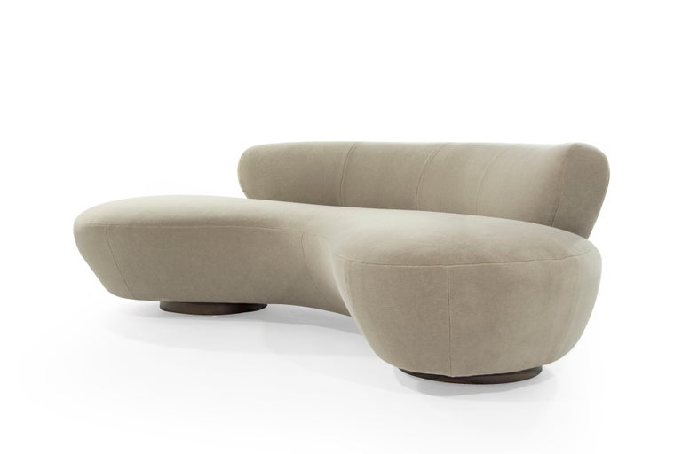 Serpentine sofa designed by the late Vladimir Kagan for Directional, circa 1970s. This rare example features fully restored walnut bases as well as Lucite support.

Newly upholstered in natural alpaca velvet.
      