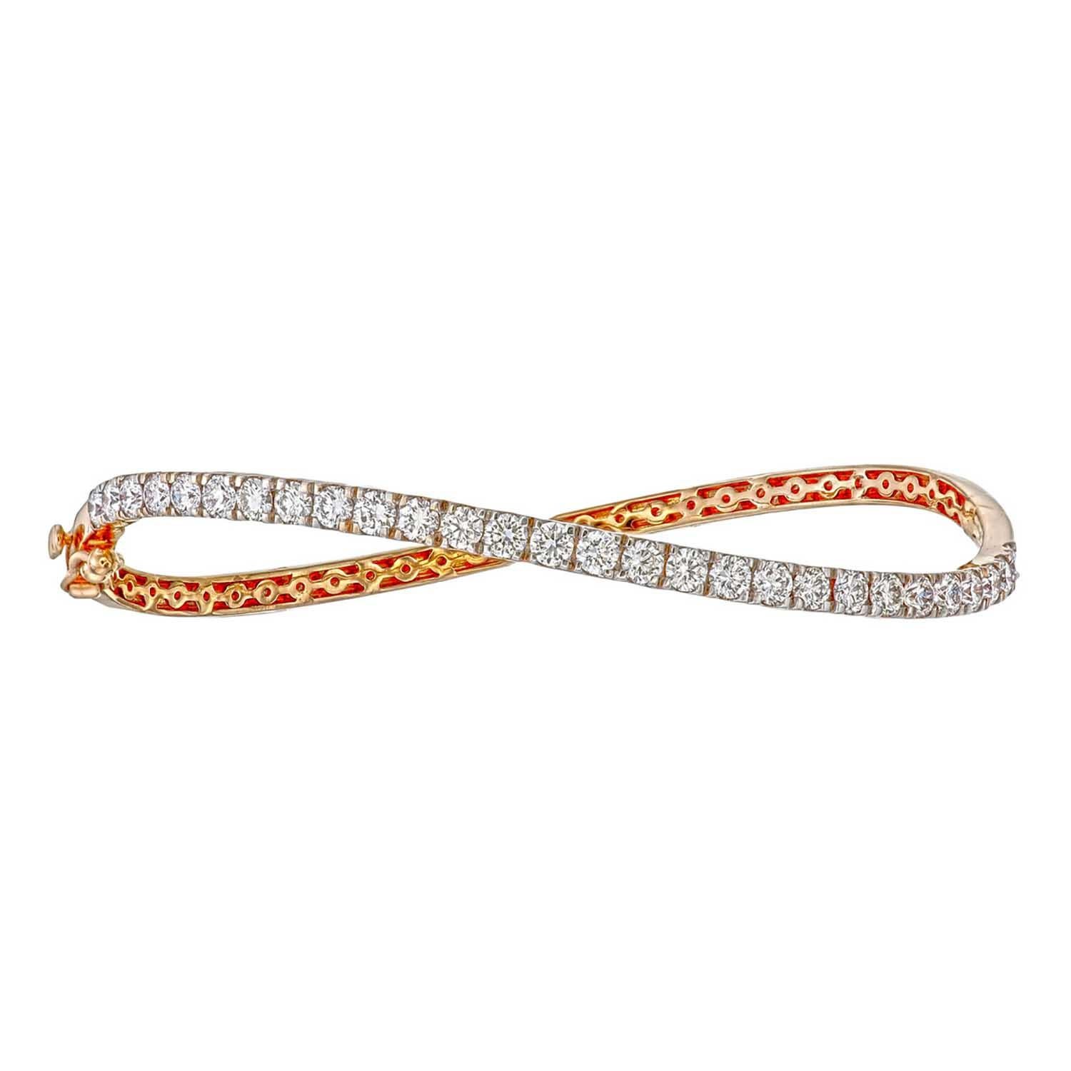 18k gold diamond curved bangle in 6.5 inches in length
The sleek design of this diamond-encrusted wave bangle flatters every wrist. -
 18K gold weighing 10 grams with 29 round diamonds totaling 1.80 carats

 Available in yellow, white, and rose